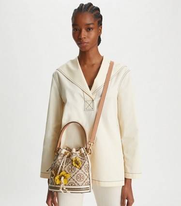 TORY BURCH T MONOGRAM FLORAL BUCKET BAG คอลเลคชั่นใหม่ พร้อมเสิร์ฟความสวยให้ถึงบ้าน!! กระเป๋าบัคเก็ตทรงยอดนิยม ดีไซน์ใหม่ล่าสุด สไตล์งานคราฟ มีลูกเล่นประดับดอกไม้กับตัวกระเป๋า และตัวรูดสาย วัสดุผ้า jacquard ตัดสลับหนังแท้ หูจับและขอบกระเป๋าตกแต่งลายสานสวย