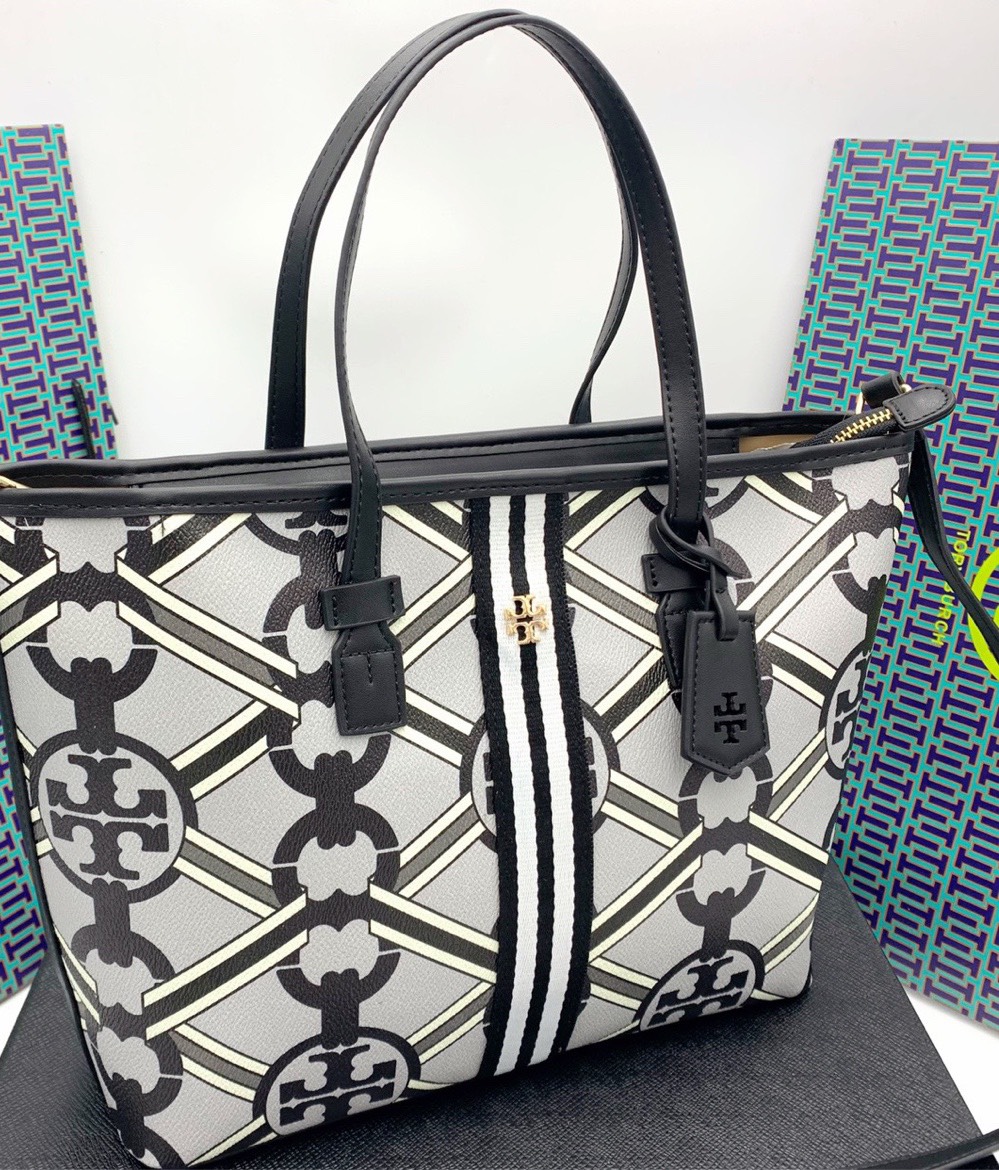 Tory burch Gemini Link Canvas Top Zip Tote Bag สำหรับ Collection นี้คาดว่าน่าจะเป็นรุ่นที่สะดุดตาใครหลายคนอย่างแน่นอน เพราะ "Gemini Link" หรือ "เจมิไน ลิงค์” จุดเด่นคือลวดลายโซ่อันเรียบหรูที่สามารถสะกดทุกสายตา ใครได้เห็นก็ต้องรู้เลยว่าเป็นแ