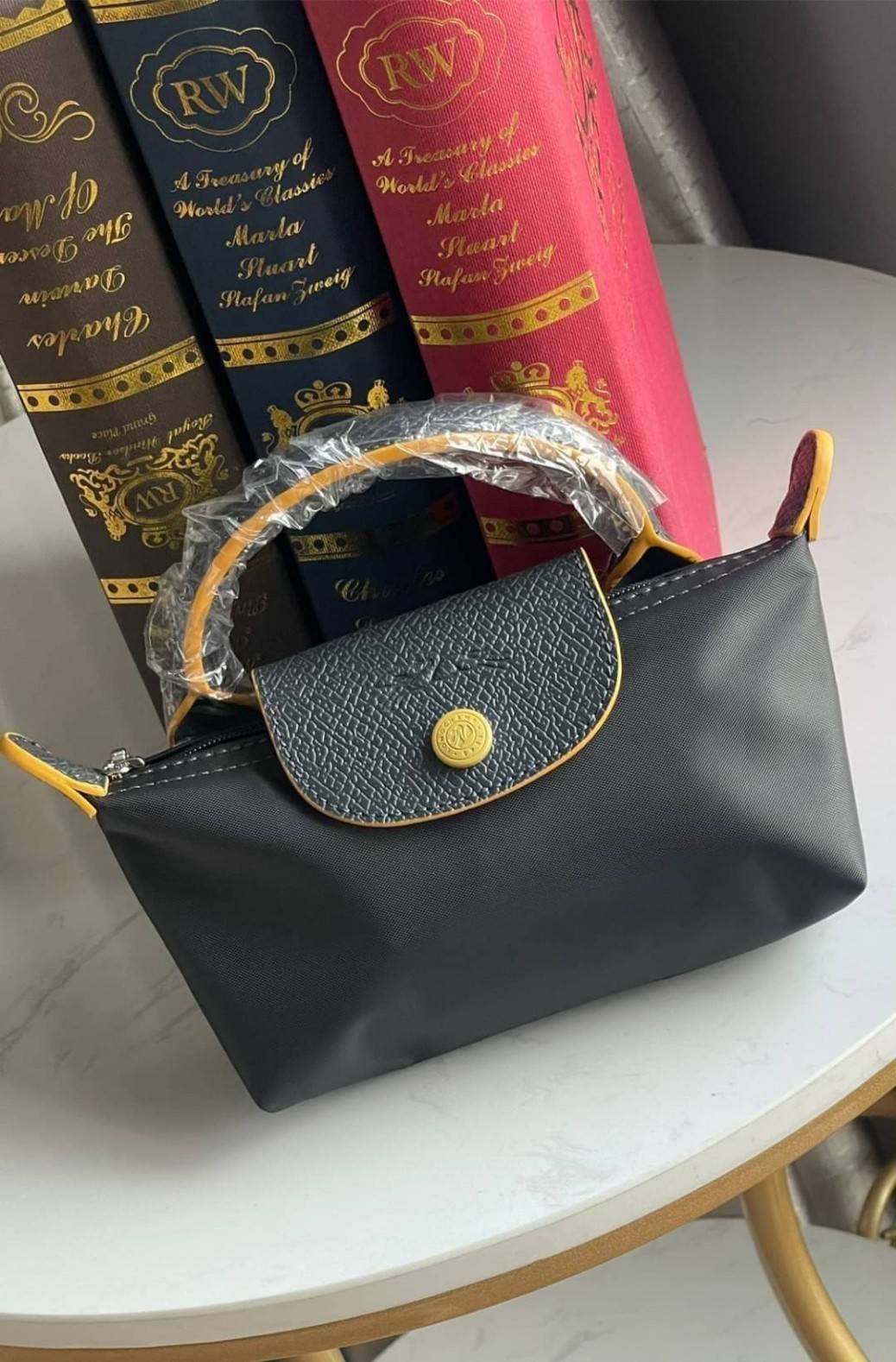 LONGCHAMP LE PLIAGE ORIGINAL Pouch with handle กระเป๋าถือขนาดมินิทรงpouch ให้ความหรูหราจาก Le Pliage (เลอ ปลิยาจ) ในขณะที่ที่ปิดแบบซิปช่วยให้คุณมั่นใจได้