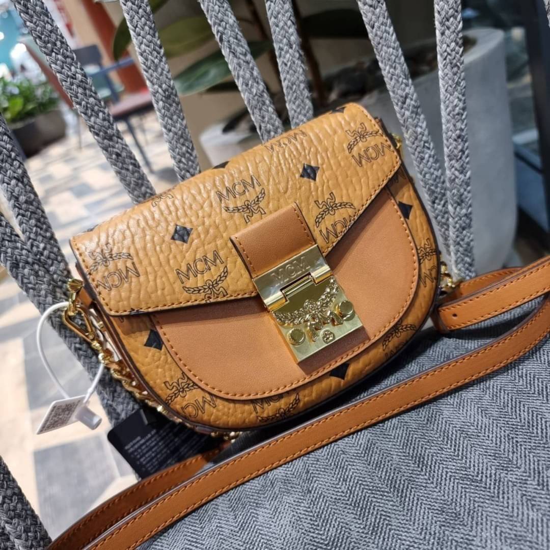 M.C.M MINI PATRICIA CROSSBODY IN VISETOS กระเป๋าสะพายไซส์มินิ แรงดีไม่มีตกน้า คอลเลคชั่นนี้ดีไซน์แปลกใหม่ ทรงโค้งมน สวยหรู ด้านข้างตกแต่งหมุดทองรอบใบ วัสดุตัวกระเป๋าเป็นหนังแคนวาสคุณภาพดี ภายในเป็นหนังกลับสีส้มโดดเด่นเป็นเอกลักษณ์ มีช่องใส่บัตรแยกให้ เปิด
