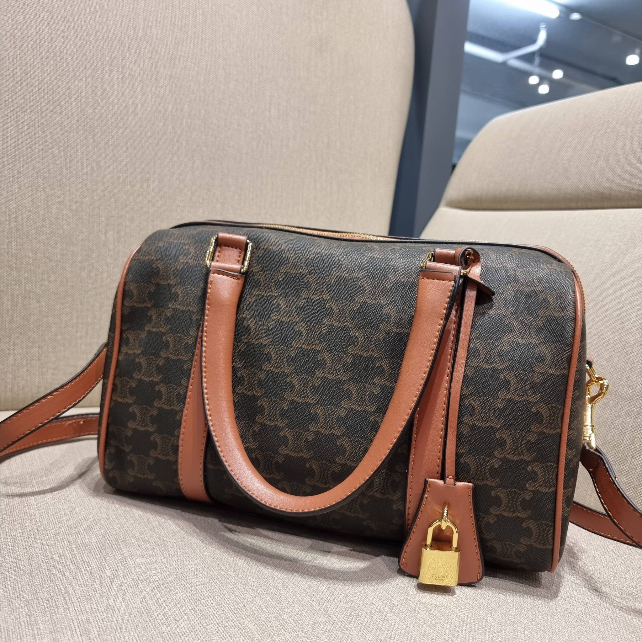 CELINE BOSTON BAG IN TRIOMPHE CANVAS AND CALFSKIN ยอดฮิตกับลวดลายเอกลักษณ์ สุดคลาสสิค กับกระเป๋ากึ่งเดินทาง ไซส์กำลังดี ที่สามารถใช้ได้ทั้งหนุ่มๆและสาวๆ วัสดุหนังแคนวาสตัดสลับหนังแท้ เปิด-ปิดด้วยซิป ใช้งานสะดวก และยังมีพวงหนังห้อยและแม่กุญแจล็อคซิปได้ มาพ
