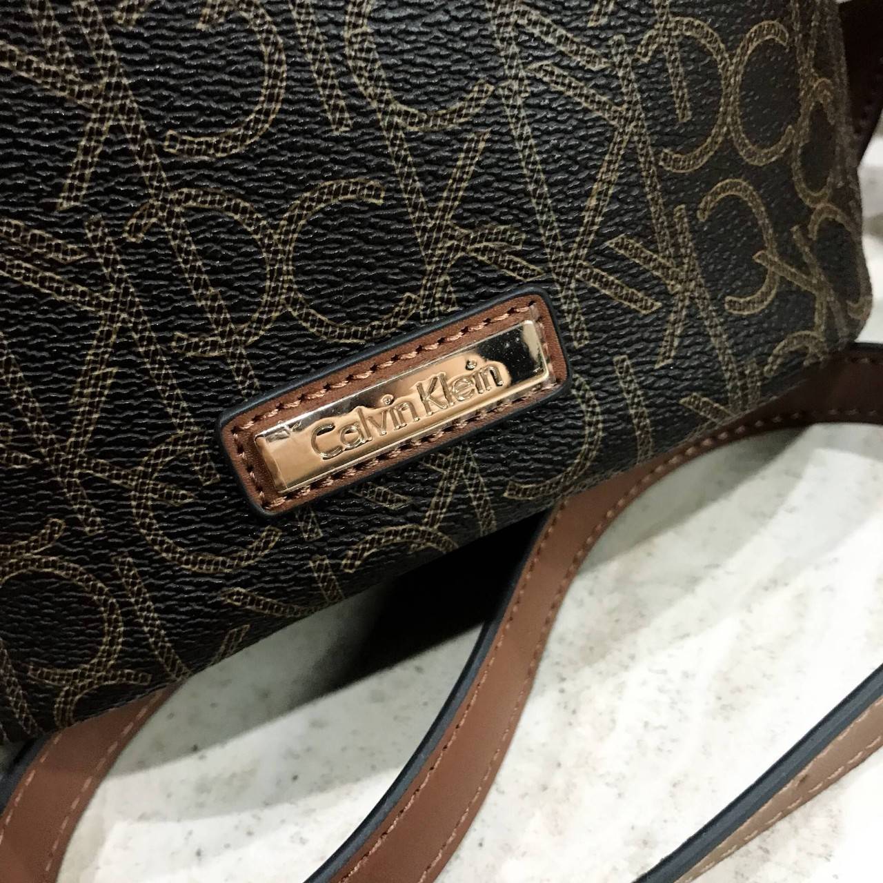 Calvin Klein CrossBody Bag Y2019 Newvin! กระเป๋าสะพายหนังสวยอยู่ทรง ลาย Signature แบรนด์รอบใบ ทรงถัง เปิดปิดด้วยซิป ด้านหน้าประดับโลโก้แบรนด์ อะไหล่ทอง ขนาดกำลังดี น้ำหนักเบา ภายในกว้าง ซับในพิมพ์แบรนด์ ใส่ wallet ยาวได้ พร้อมสายยาว ปรับได้ Crossbodyได้ค่