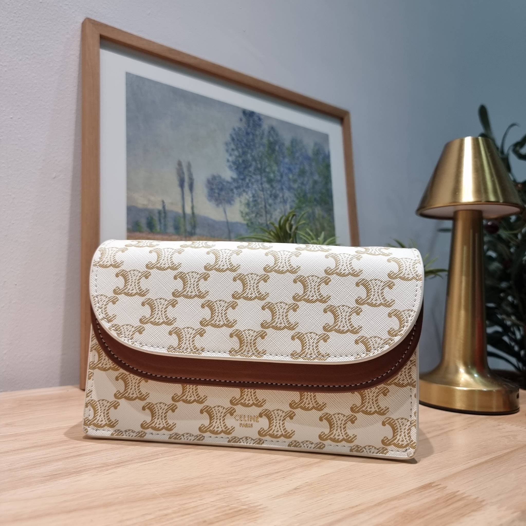 CELINE WALLET ON STRAP IN TRIOMPHE CANVAS AND LEATHER อีกหนึ่งรุ่นยอดนิยม กระเป๋าสะพายกึ่งคลัทช์ ในรูปแบบกระเป๋าสตางค์ ให้พกพาได้ง่าย ใส่ของสำคัญ มือถือ หรือบัตรต่างๆได้