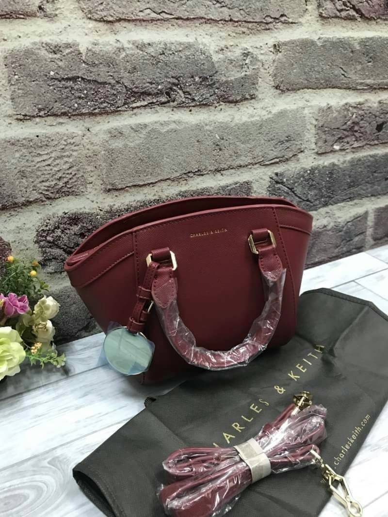 CHARLES & KEITH CURVED CITY BAG Re stock & Best seller กระเป๋าถือหรือสะพาย ขนาดกำลังดี วัสดุหนังPU ลายคาร์เวียร์ ตั้งอยู่ทรง มีหมุดรองฐาน เปิดปิดด้วยซิปเดียว ภายในมี 2 ช่องเล็ก และ 1 ช่องซิปด้านข้าง ใส่มินิ ไอแพด, กระเป๋าสตางค์ทรงยาวได้ ด้านหน้าประดับด้วย