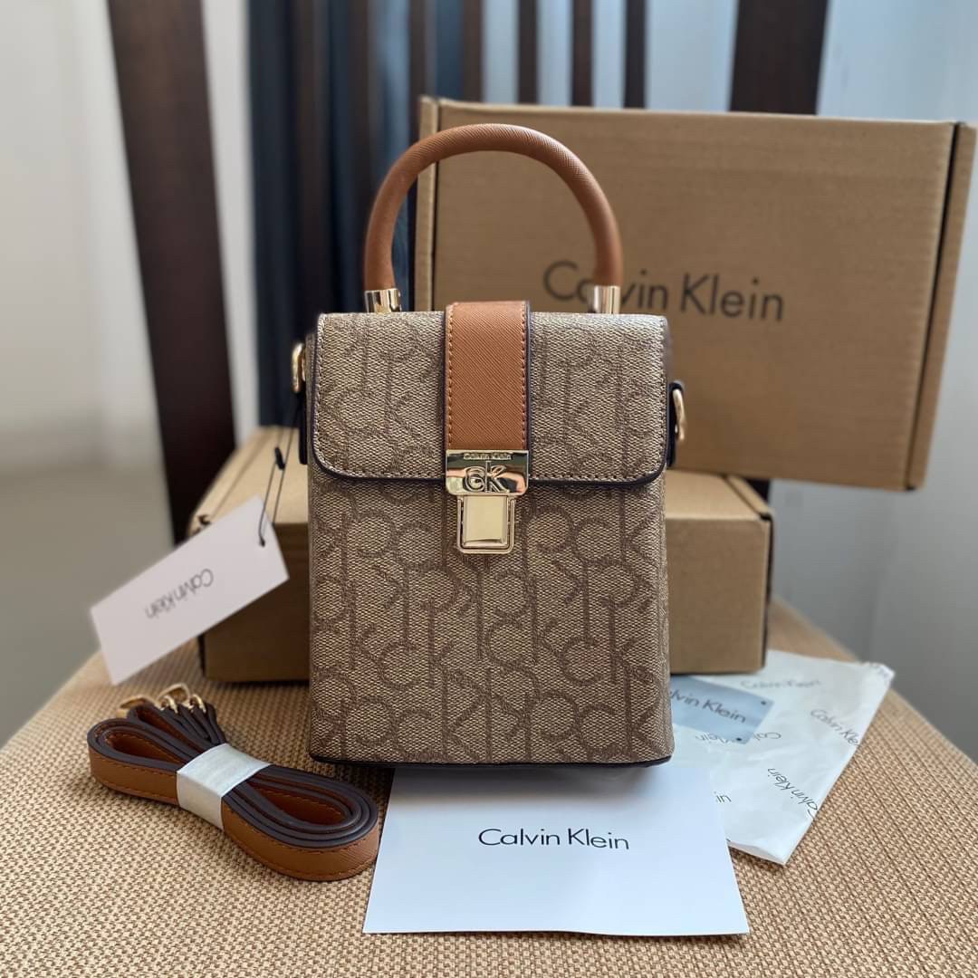 CALVIN KLEIN JEANS crossbody bag กระเป๋าถือหรือสะพาย ลายซิกเนเจอร์แบรนด์ทั้งใบ มีหูจับสำหรับถือ เปิด-ปิดกระเป๋าด้วยกระดุมแม่เหล็ก ด้านในโล่งกว้างมีช่องเล็กและช่องซิปสำหรับใส่ของจุกจิก ซับในลายแบรนด์อย่างดี มาพร้อมสายสะพายยาวปรับระดับได้ สามารถใช้ได้หลากหล