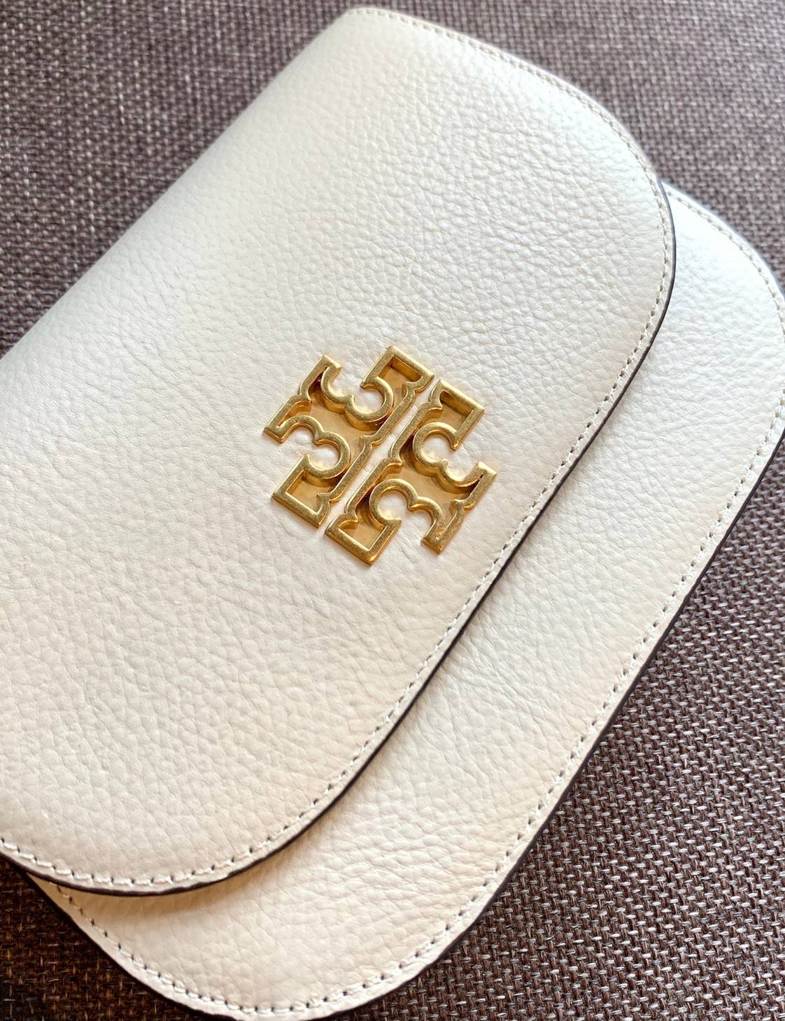 TORY BURCH BRLTTEN SMALL SADDLE BAG / Tory Burch Britten Flap Shoulder Bag กระเป๋าสะพายข้าง วัสดุหนังแกะแท้ ด้านหน้าประดับโลโก้แบรนด์ เปิด-ปิดกระเป๋าแบบกระดุมแป็กแม่เหล็กแน่นหนา ภายในมีช่องหลัก ใส่กระเป๋าเงินใบกลาง มือถือได้ทุกรุ่น มีช่องแยกใส่ของจุกจิกอี
