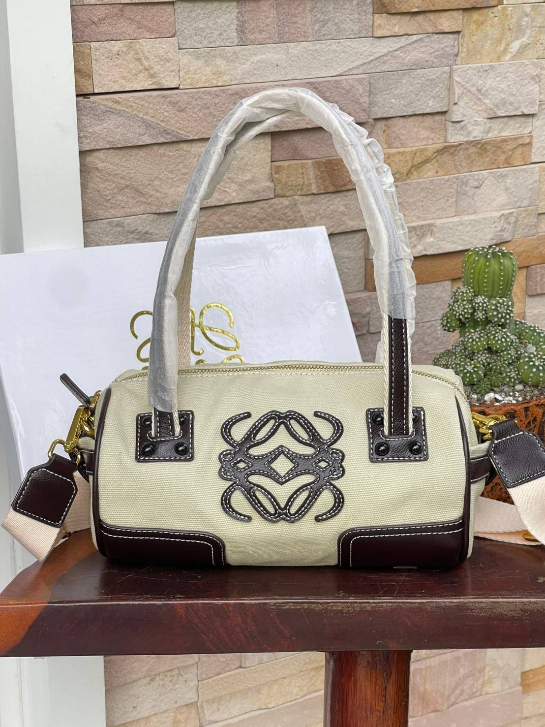 LOEWE ANAGRAM LOGO EMBROIDERED CANVAS VINTAGE MINI SHOULDER BAG กระเป๋าทรงหมอนแบบสะพายไหล่โลเอเว่ ด้านหน้าปักสัญลักษณ์โลโก้แอนนาแกรม สายหนังแท้ เป็นรุ่นที่มีขนาดไม่ใหญ่มาก แต่สามารถใส่ของสำคัญของตนเองเข้าไว้ข้างในได้ครบครัน นอกจากนี้ยังใช้ซิปยาว และซิปสอง