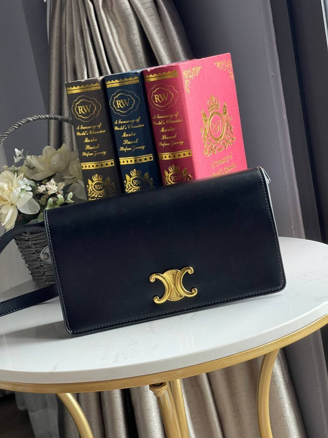 CELINE TRAPEZE TRIOMPHE BAG ดีไซน์เรียบหรู Timeless โดดเด่นมีเอกลักษณ์ ใช้ได้หลายโอกาส แมทช์กับการแต่งตัวง่าย จึงครองใจสาว ๆ ได้ไม่ยาก โดยเป็นกระเป๋าสะพายไหล่ที่อัดแน่นด้วยกลิ่นอายความคลาสสิกและหรูหราตามแบบฉบับของ Celine ด้านหน้าตกแต่งด้วยโลโก้สีทองโดดเด่