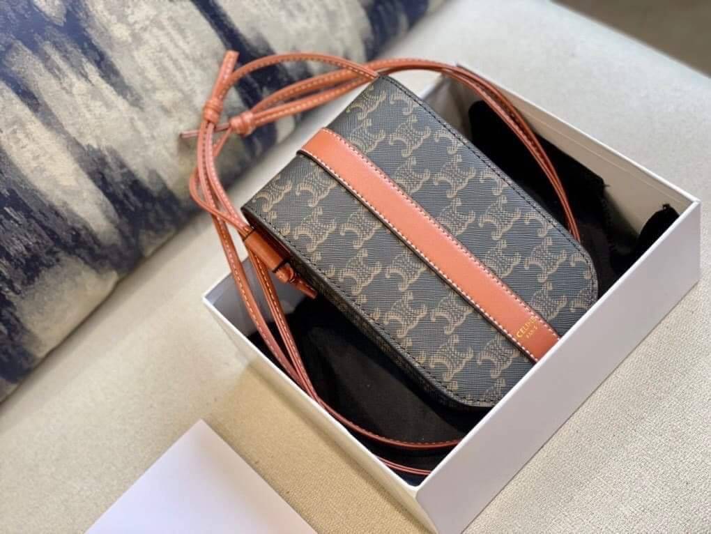 Celine Phone Pouch in Triomphe Canvas and Calfskin Tan / Celine phone bag กระเป๋าใส่โทรศัพท์เรียบหรู ด้วยลวดลาย Triompe ที่แสดงถึงความเป็นเอกลักษณ์ของแบรนด์ ช่องหลักที่มีความกว้าง สามารถใส่โทรศัพท์มือถือ ธนบัตร บัตรต่าง ๆ และของจุกจิกชิ้นเล็ก ๆ ได้แบบจุใจ