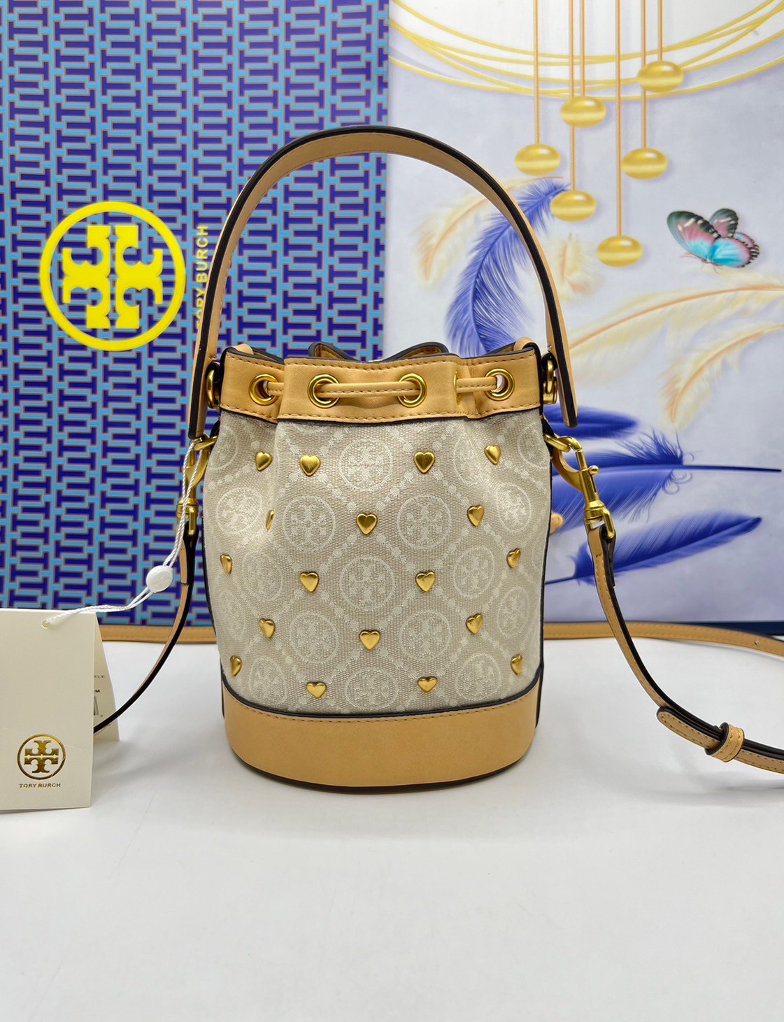 TORY BURCH T MONOGRAM EMBELLISHED MINI BUCKET BAG NEW IVORY MULTI กระเป๋าทรงบัคเก็ตแต่งหัวใจสีทองสวยหรู น่ารักรุ่นใหม่ล่าสุด เกรดท็อปออริ เทียบแท้ 1:1 เกรดดีสุด ใช้งานต่างประเทศได้