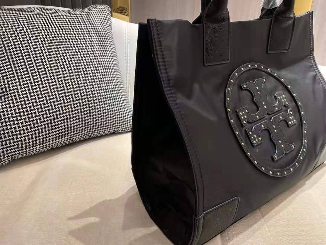 TORY BURCH ELLA TOTE BAG *BUY1GET1 สวยคุ้มในราคาสบายกระเป๋า‼️ กระเป๋าทรง SHOPPING วัสดุ NYLON ทั้งใบตัดด้วยหนัง SAFFIANO ดำ ตกแต่งด้วยหมุดรอบโลโก้แบรนด์ ด้านในบุผ้าปั้มแบรนด์ เปิดปิดด้วยกระดุมแม่เหล็ก ช่องกว้างหลักหนึ่งช่องและช่องซิปอีกช่อง พร้อมช่องใส่ขอ