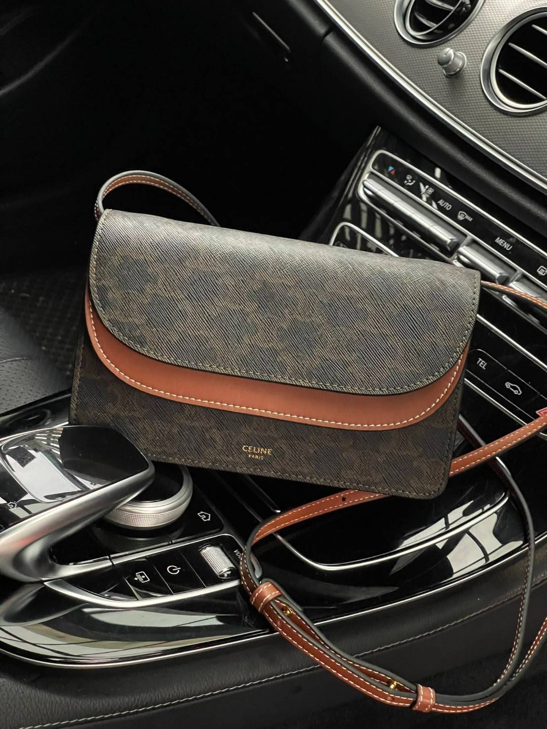 CELINE WALLET ON STRAP IN TRIOMPHE CANVAS กระเป๋าสะพายไหล่สุดเก๋ใบนี้ผลิตจากผ้าใบเคลือบอย่างดีพร้อมขอบหนังสีน้ำตาล กระเป๋ามีสายสะพายหนังสีน้ำตาลพร้อมฮาร์ดแวร์สีทอง ถอดสายออกเพื่อเป็นกระเป๋าถือทรงคลัชท์เปลี่ยนลุคช์ ลวดลายtriomphe ความเป็นแบรนด์ CELINE ได้อ