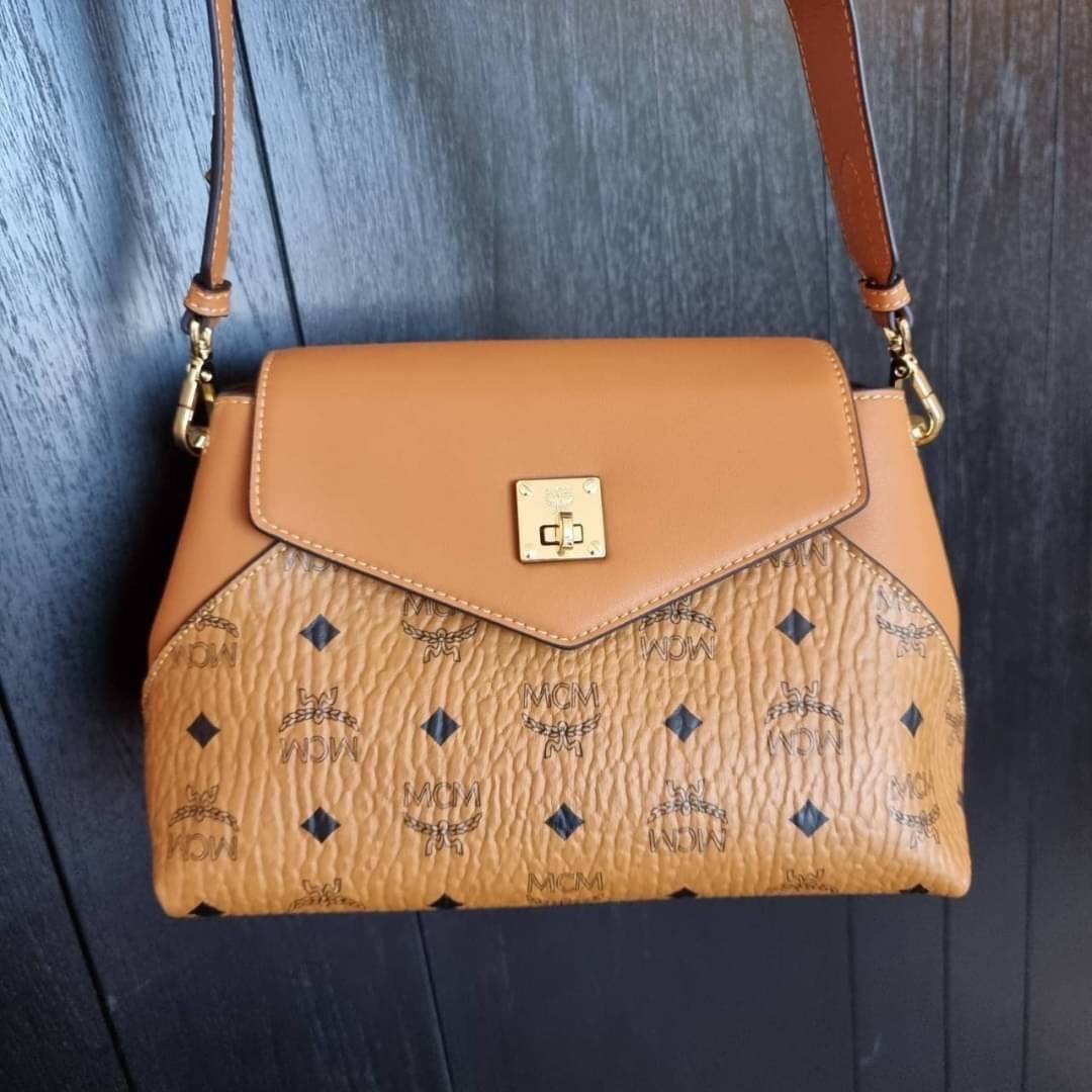 M.C.M ESSENTIAL CROSSBODY IN VISETOS กระเป๋าสะพายข้าง สวยอยู่ทรง ดีไซน์ไม่ซ้ำใคร มาพร้อมสายสะพายถึง 2 แบบ ปรับเปลี่ยนใช้ได้ไม่มีเบื่อ วัสดุหนังแคนวาสสลับหนังแท้ เปิด-ปิดกระเป๋าด้วยตัวบิดล็อคแน่นหนา ด้านหลังมีช่องเก็บบัตรได้ ภายในโล่งกว้าง แบ่งสัดส่วน เป็น