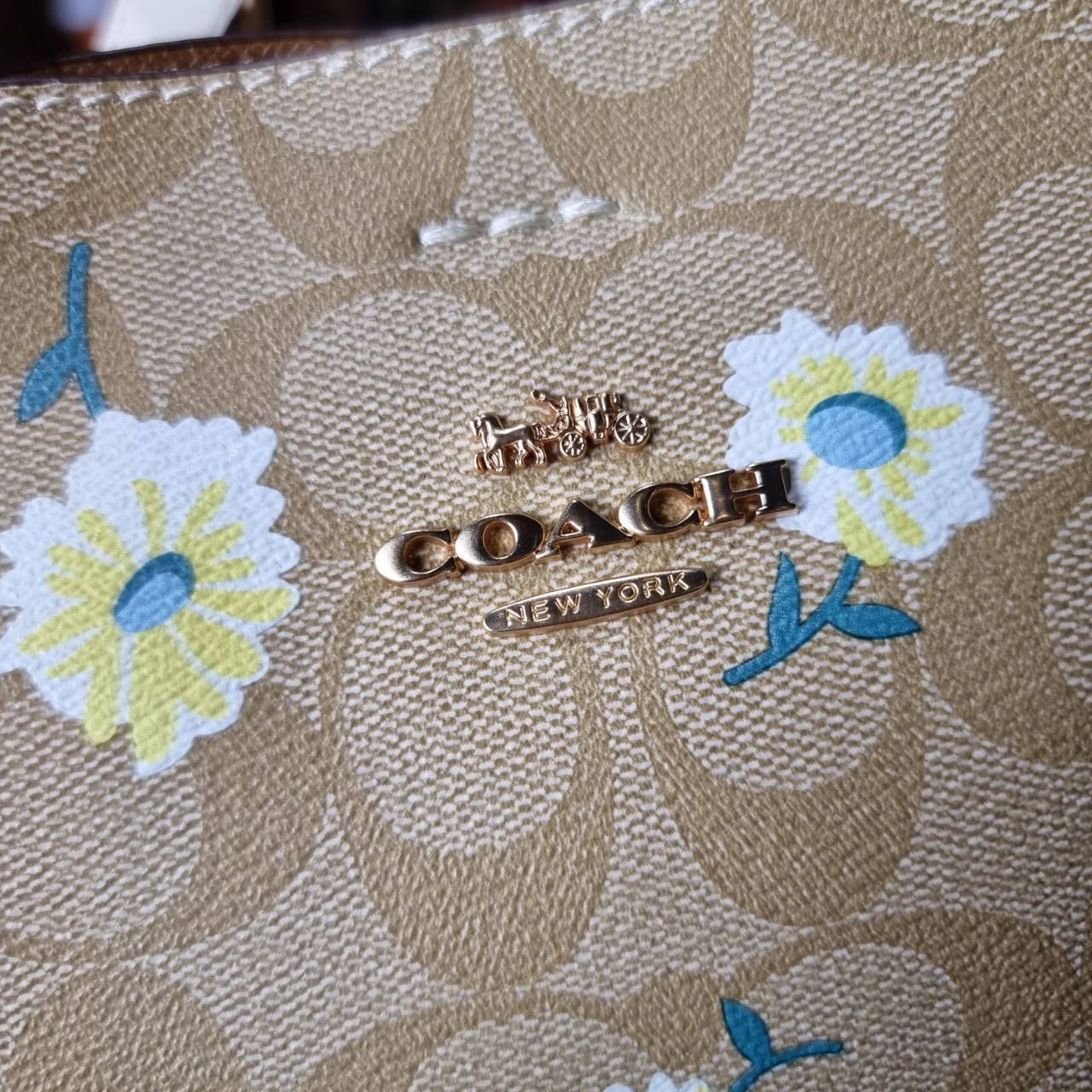 OUTLET 】COACH C3411 SMALL TOWN BUCKET BAG IN SIGNATURE CANVAS WITH DAISY PRINT สวยสดใสมาให้ถึงบ้านจ้า!! กระเป๋าทรงบัคเก็ตยอดฮิต รอบนี้น่ารักมุ้งมิ้งไม่เลิก ดีไซน์ลายดอกเดซี่คละรอบใบ วัสดุหนังแคนวาสเคลือบลาย ปากกระเป๋าเปิด-ปิดด้วยกระดุมแม่เหล็ก 2ฝั่ง มีหูจ