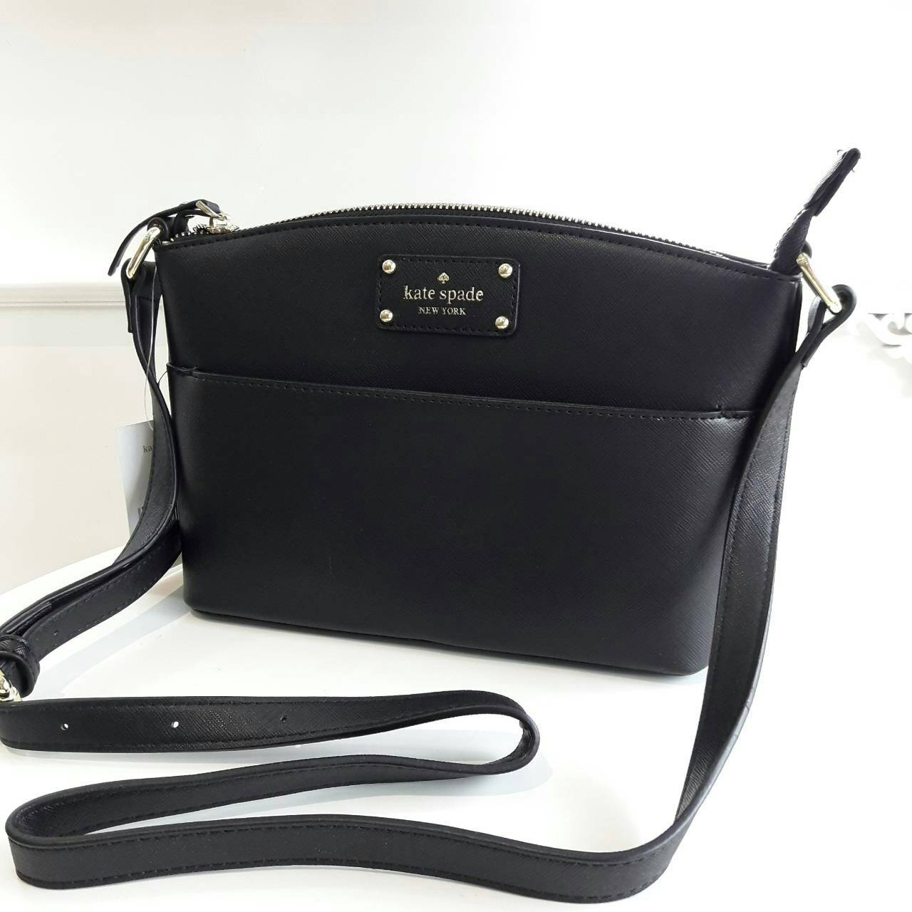 Kate Spade New York Mini Cross Body Bag กระเป๋าถือหรือสะพายหนัง Saffiano สวยหรูอยู่ทรงสไตล์ PRADA ด้านหน้าประดับโลโก้สีทองสวยไฮโซ มาพร้อมสายสะพายยาวปรับได้ ภายในมีช่องซิปและช่องเล็ก ซับในอย่างดีสกรีนลายตามแบบฉบับของแบรนด์ภายในกว้างจุใส่กระเป๋าสตางค์ใบยาวข