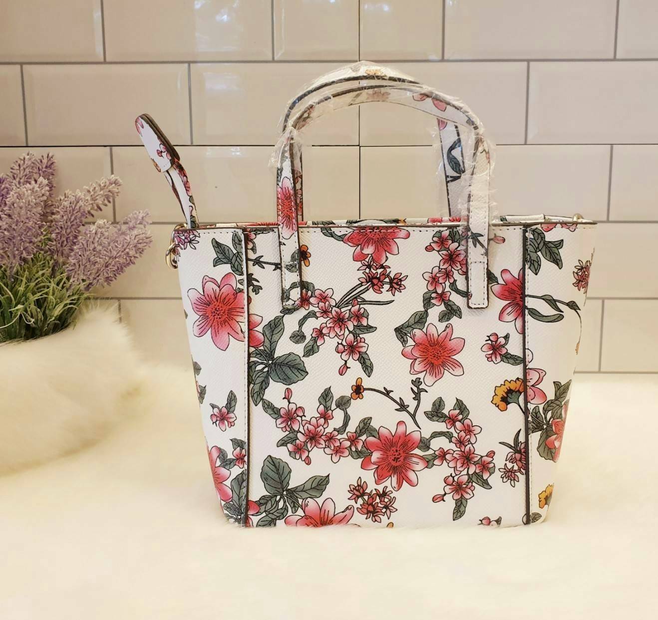 GUESS OPEN ROAD FLORAL MINI TOTE กระเป๋าถือหรือสะพายขนาดกำลังดี วัสดุหนังซาฟิโน่แต่งลายดอกไม้อ่อนหวานสดใส ฐานตั้งอยู่ทรง เปิดปิดด้วยซิป ใส่กระเป๋าสตางค์ยาวได้ สายสะพายปรับระดับได้ สวยน่าใช้จริงๆจ้า