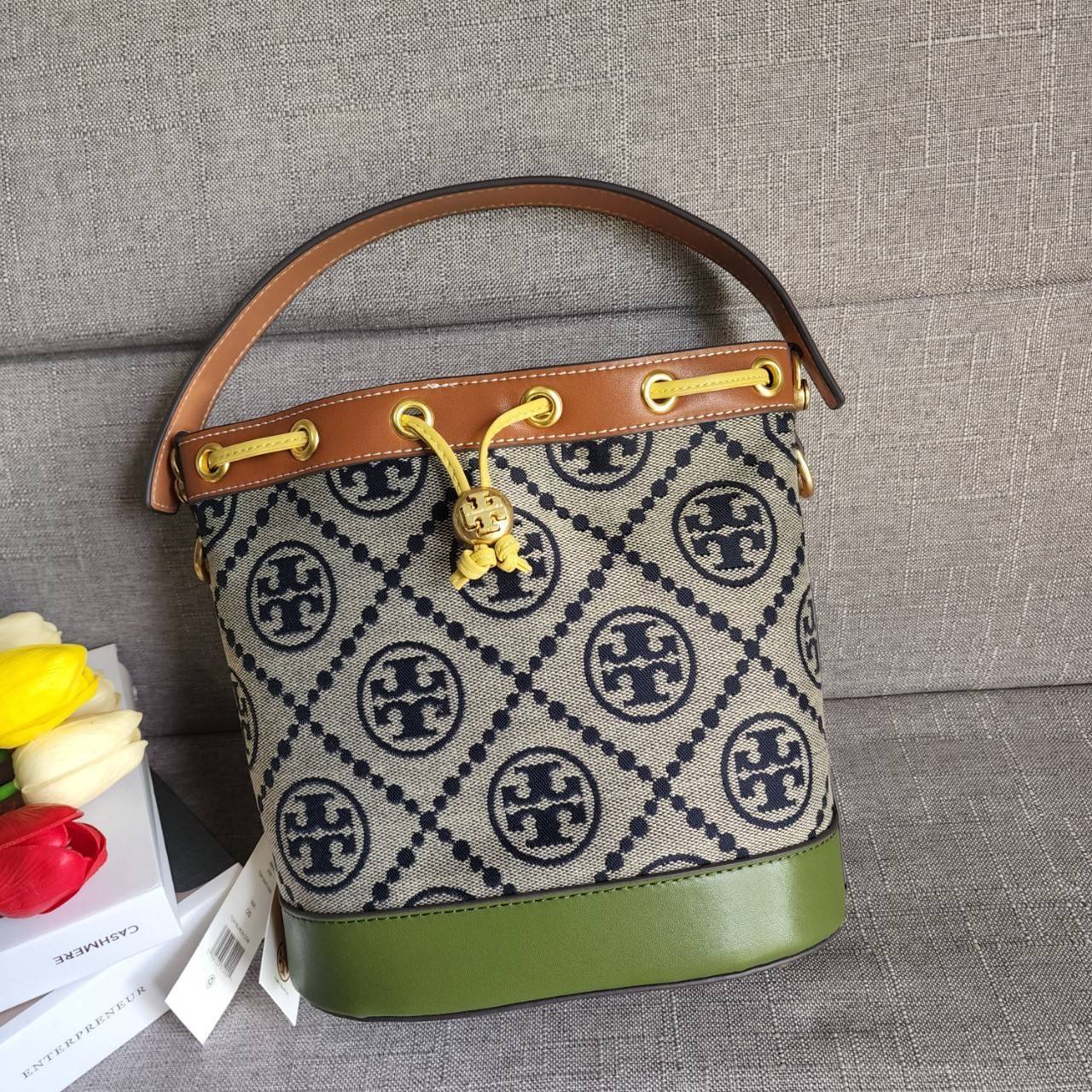 Tory Burch T Monogram Colorblock Bucket Bag กระเป๋าสะพาย ทรงบัคเกต รุ่นฮอต สไตล์ไหนเข้าได้ทุกลุค วัสดุ jacquard ตัดขอบหนังแท้ ภายในเป็นช่องโล่งกว้าง ใส่ของได้เยอะหยิบจับสะดวก มาพร้อมสายสะพายข้างหนังแท้ ถอดและปรับระดับได้สะพายชิวได้ทุกโอกาส