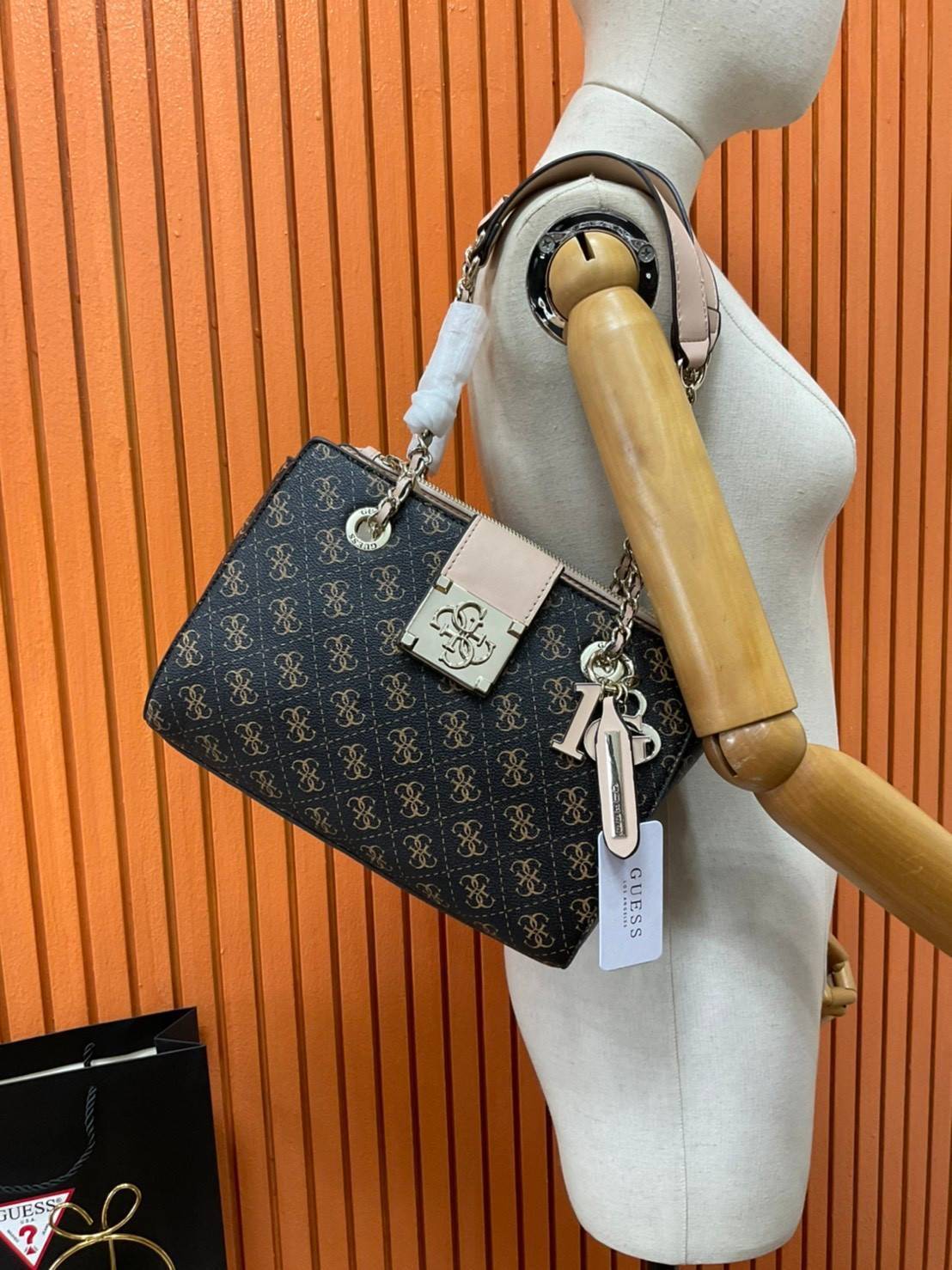 กระเป๋าสะพายไหล่ Guess Logo City Small Society Satchel กระเป๋าสะพายไหล่ ขนาดกำลังดี วัสดุ pu สวยอยู่ทรง มาพร้อมพวงกุญแจน่ารักๆ ถอดออกได้ ด้านหน้าประดับโลโก้แบรนด์ เปิดปิดด้วยซิป มี 2 ช่องหลักใช้งาน ภายในช่องซิปหน้าแยกเป็นสัดส่วนการใช้งาน ซิปช่อง 2 โล่งกว้