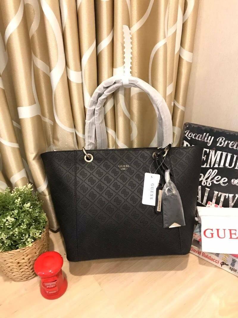 GUESS Kamryn Q Logo Tote สไตล์คลาสสิค ฐานกว้างตั้งอยู่ทรง วัสดุหนังpuลายsignature แบรนด์รอบใบ เปิดปิดด้วยซิปเดียวด้านบน ใช้งานง่าย บุด้วยผ้าสกรียโลโก้ มีช่องเล็กและช่องซิปแยกใช้งานเป็นสัดส่วน ประดับtagโลหะหุ้มหนังเป็นดีเทล ใบใหญ่ใส่นิตยสาร และของใช้ประจำว