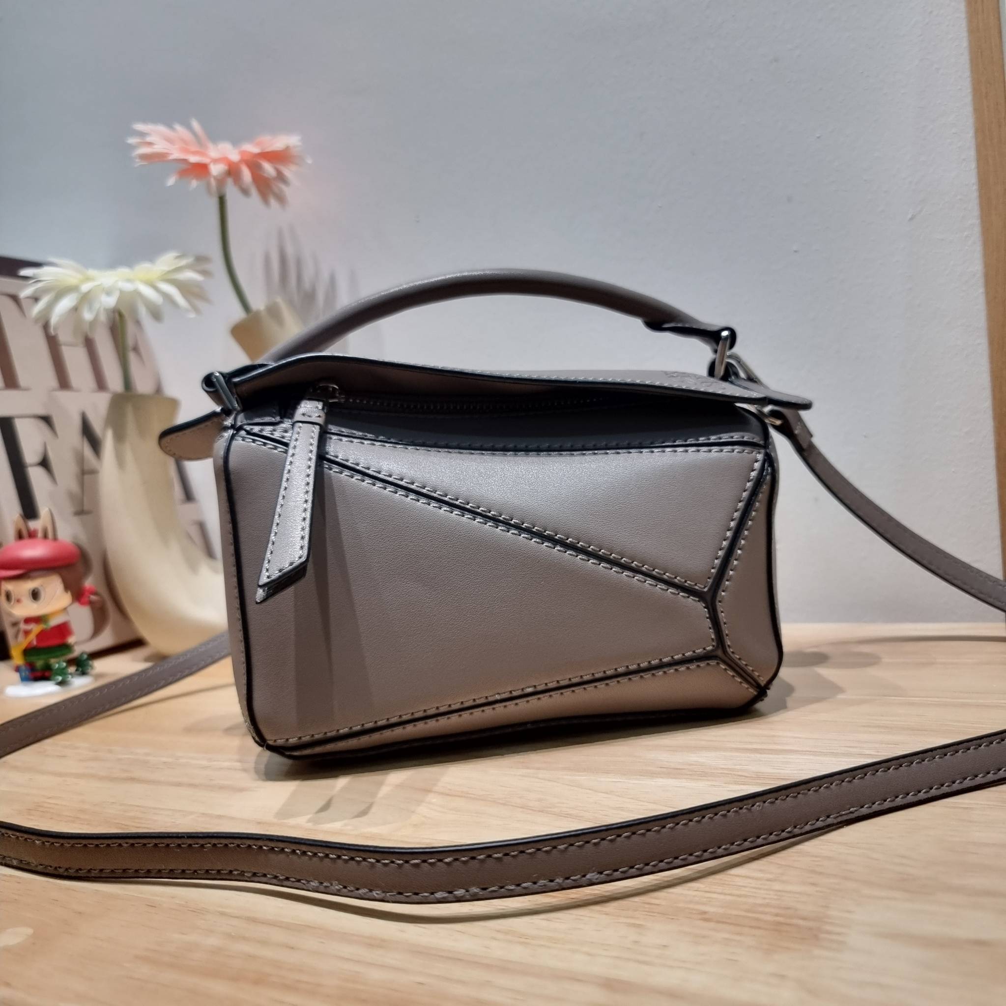 LOEWE MINI PUZZLE BAG IN CLASSIC สุดยอดแบรนด์ที่ดีไซน์เป็นเอกลักษณ์ โดดเด่น สวยหรู กับกระเป๋าสะพายข้างทรงกล่อง ไซส์มินิ สไตล์พัซเซิล ให้ฟีลลิ่งเหมือนตัวต่อคละสี ดูดีได้ทุกที่แค่มีใบนี้