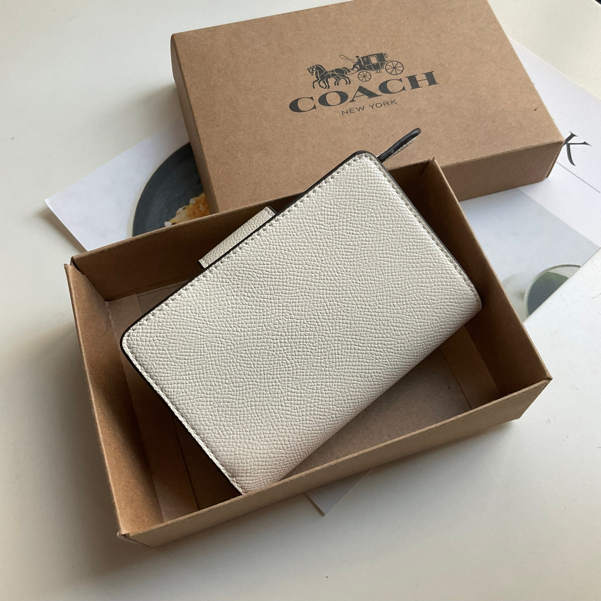 COACH SMALL WALLET IN SIGNATURE CANVAS กระเป๋าสตางค์ใบกลาง แบบพับสองตอน เปิดปิดด้วยกระดุมปั้มแบรนด์ ด้านในมีช่องใส่บัตรหลายช่อง พร้อมช่องใส่รูป และช่องใส่ธนบัตร ด้านหลังมีช่องซิปเหรียญอีกหนึ่งช่อง น้ำหนักเบา พกพาสะดวก อะไหล่ทองสุดหรู ห้ามพลาดค่ะ!