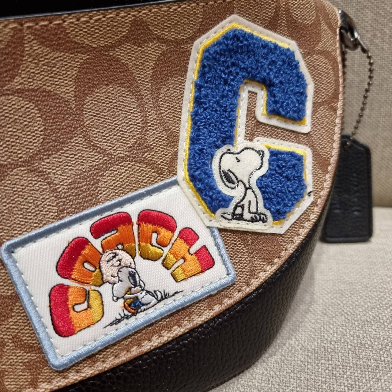 COACH C4028 COACH x PEANUTS WARREN BELT BAG IN SIGNATURE CANVAS WITH VARSITY PATCHES กระเป๋าคาดอกไซส์ใหญ่ คอลเลคชั่นยอดฮิต!! เป็นรุ่นสุดยอดของความคลาสสิค ขนาดสะพายกำลังเท่ คูลๆ ใช้งานง่าย ได้ทั้งหนุ่มๆและสาวๆ วัสดุหนังแคนวาสเคลือบลายสลับหนัง pepble น่าใช้