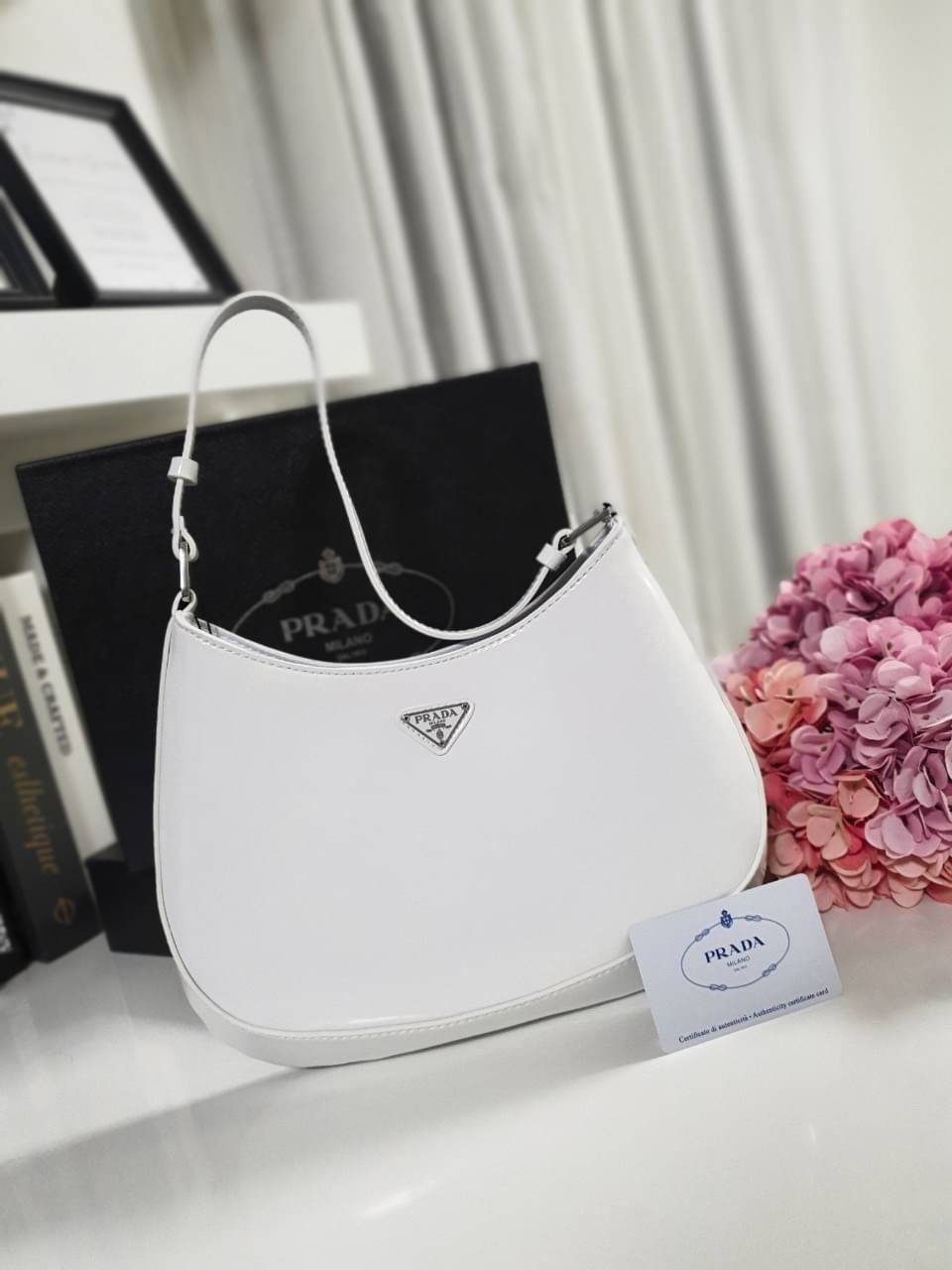 Prada Cleo brushed leather shoulder bag กระเป๋าทรงสวยยอดฮิต กับแบรนด์ PRADA งานพรีเมียมกิ้ฟท์จากแบรนด์ ทรงสะพายไหล่สวยหรูอยู่ทรง PRADA CLEO หนังเรียบดำเงาหรูสุดคลาสสิต เปิดปิดด้วยกระดุมอะไหล่เงินทั้งใบ ด้านในใส่กระเป๋าสตางค์ยาว มือถือ ของจุกจิกได้เยอะ มีป