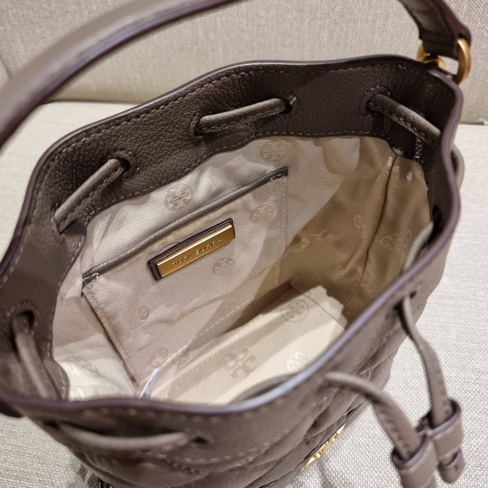 TORY BURCH WILLA MINI BUCKET BAG NEW ARRIVAL สุดปัง กระเป๋าสะพายทรงบัคเก็ต สวยผู้ดี โดดเด่นด้วยโลโก้สีทองดูหรู อัพลุคผู้ดี๊ผู้ดี วัสดุหนังแท้ ดีไซน์บุนวม เส้นคมดีเทลหรู เปิด-ปิดหนังรูดปากกระเป๋า มีหูหิ้วในตัว คล้องแขนเก๋ๆ ภายในเป็นช่องโล่ง มีช่องย่อย ใส่ข