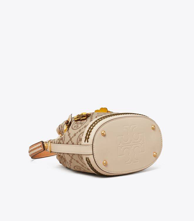 TORY BURCH T MONOGRAM FLORAL BUCKET BAG คอลเลคชั่นใหม่ พร้อมเสิร์ฟความสวยให้ถึงบ้าน!! กระเป๋าบัคเก็ตทรงยอดนิยม ดีไซน์ใหม่ล่าสุด สไตล์งานคราฟ มีลูกเล่นประดับดอกไม้กับตัวกระเป๋า และตัวรูดสาย วัสดุผ้า jacquard ตัดสลับหนังแท้ หูจับและขอบกระเป๋าตกแต่งลายสานสวย