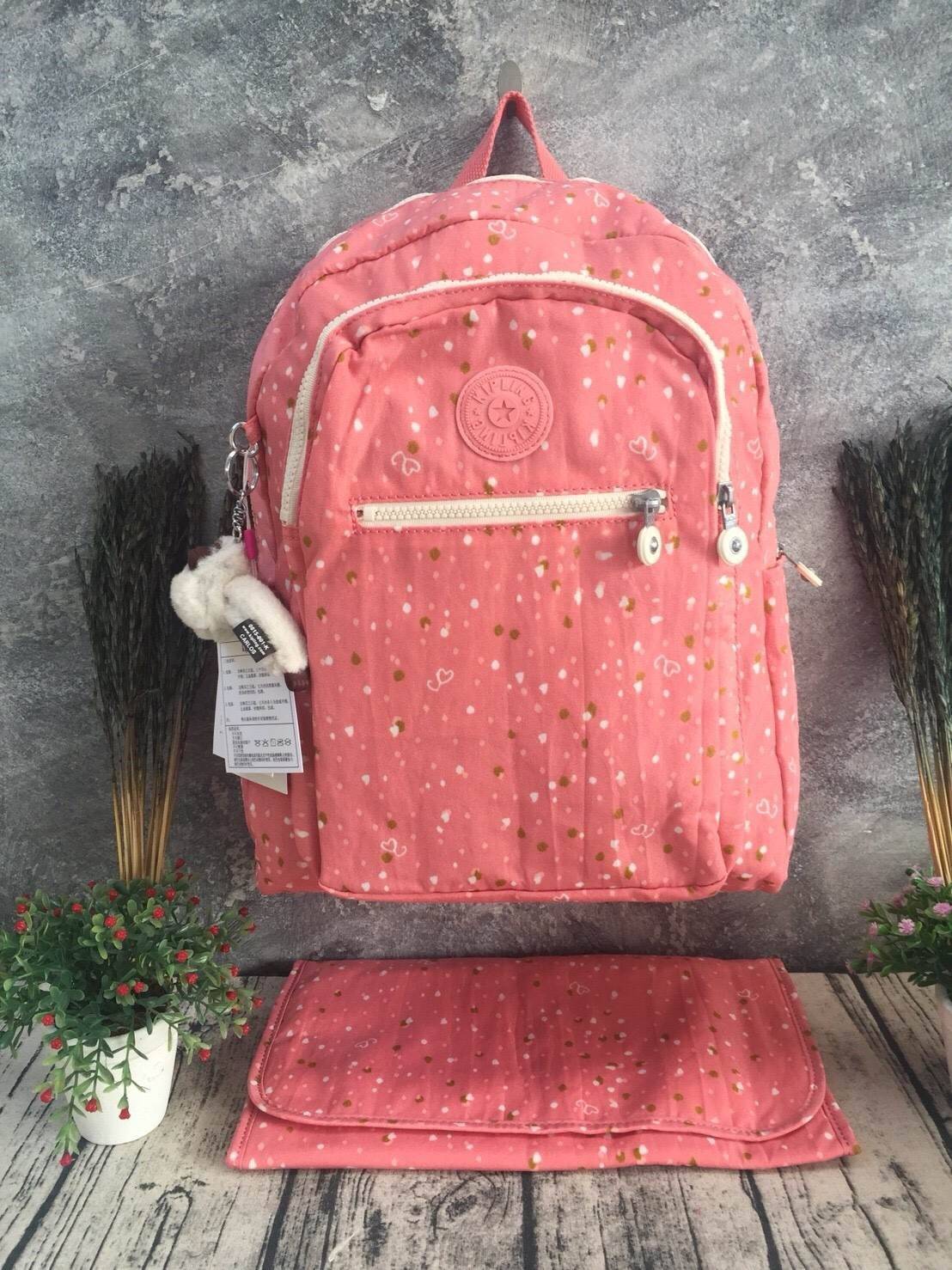 KIPLING Bizzy Boo เป็นกระเป๋าผ้าอ้อมกระเป๋าเป้สะพายหลังที่มีสไตล์ กระเป๋าเป้สะพายหลังขนาดเล็กที่มีน้ำหนักเบาและใช้งานง่ายและทำความสะอาดได้ง่ายออกแบบมาเป็นพิเศษสำหรับทารกของคุณ Bizzy Boo มาพร้อมกับกระเป๋าด้านข้างสำหรับทารกเล็ก ๆ ที่เข้ากันได้กับแผ่นรองพื้น