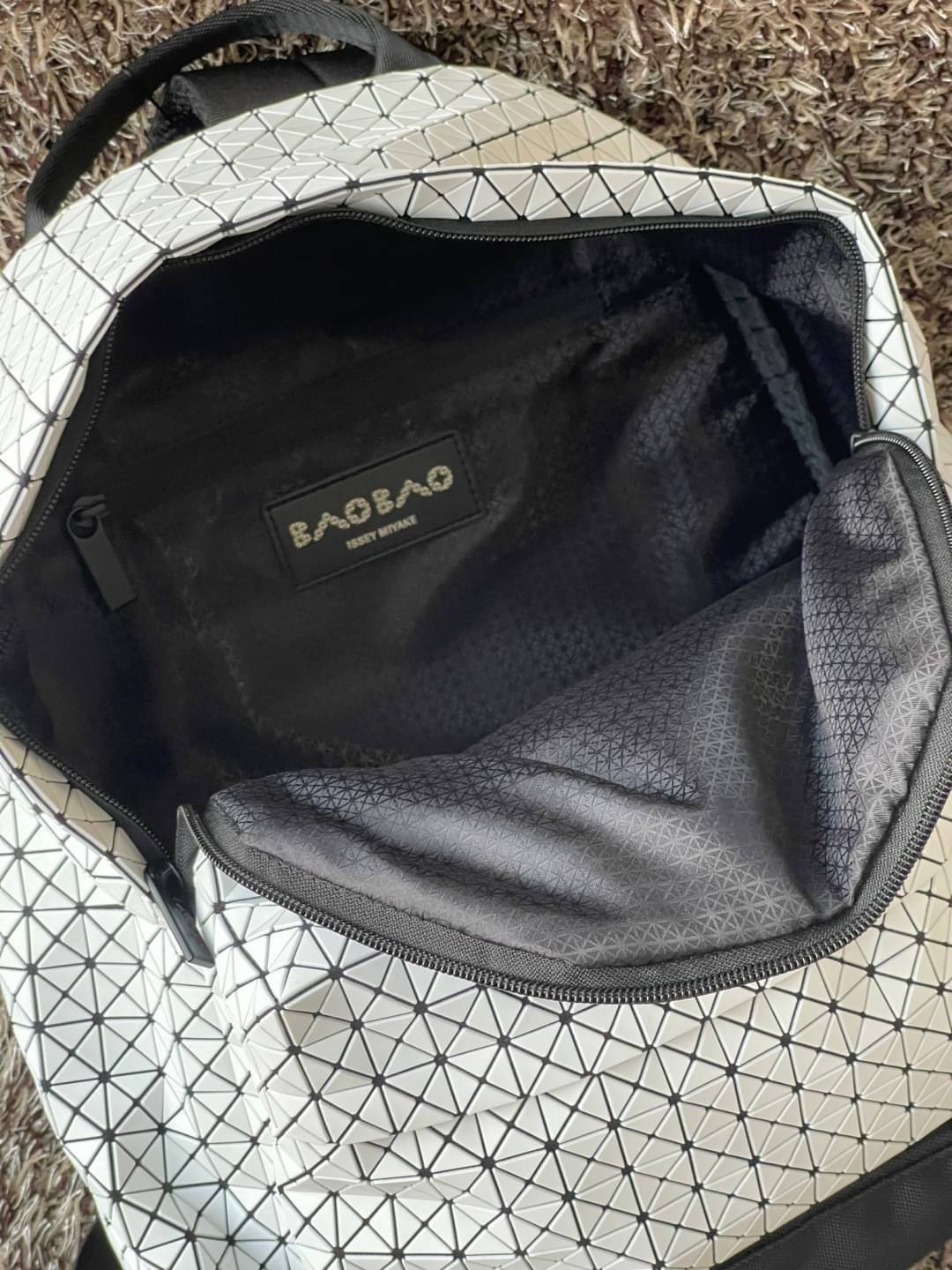 Bao Bao Issey Miyake Daypack geometric backpack กระเป๋าเป้ทรงคลาสสิก รองรับน้ำหนักได้ดี เหมาะกับการเดินทาง เป้สะพายหลังรุ่น Daypack One-Tone Backpack มาในรูปทรงกระเป๋าเป้สุดคลาสสิก โดดเด่นด้วยการออกแบบที่เป็นเอกลักษณ์ วัสดุสามเหลี่ยมขนาดเล็กพิเศษ ได้กลิ่น