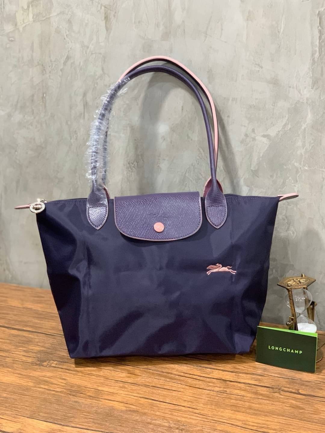 Longchamp LE PLIAGE Club (พร้อมส่ง 8 สี) TOTE BAG S กระเป๋ารุ่นยอดนิยม ที่สาวๆ ต้องมีไว้เก็บไว้สักใบ ด้วยตัวน้ำหนักกระเป๋า Longchamp เบาแสนเบา แต่จุของได้เยอะมาก สำหรับลุคทางการกึ่งลำลอง แฝงความสบาย ยามเดินทาง จุดเด่นอย่างหนึ่งของ กระเป๋าก็คือ สามาถพับเก็