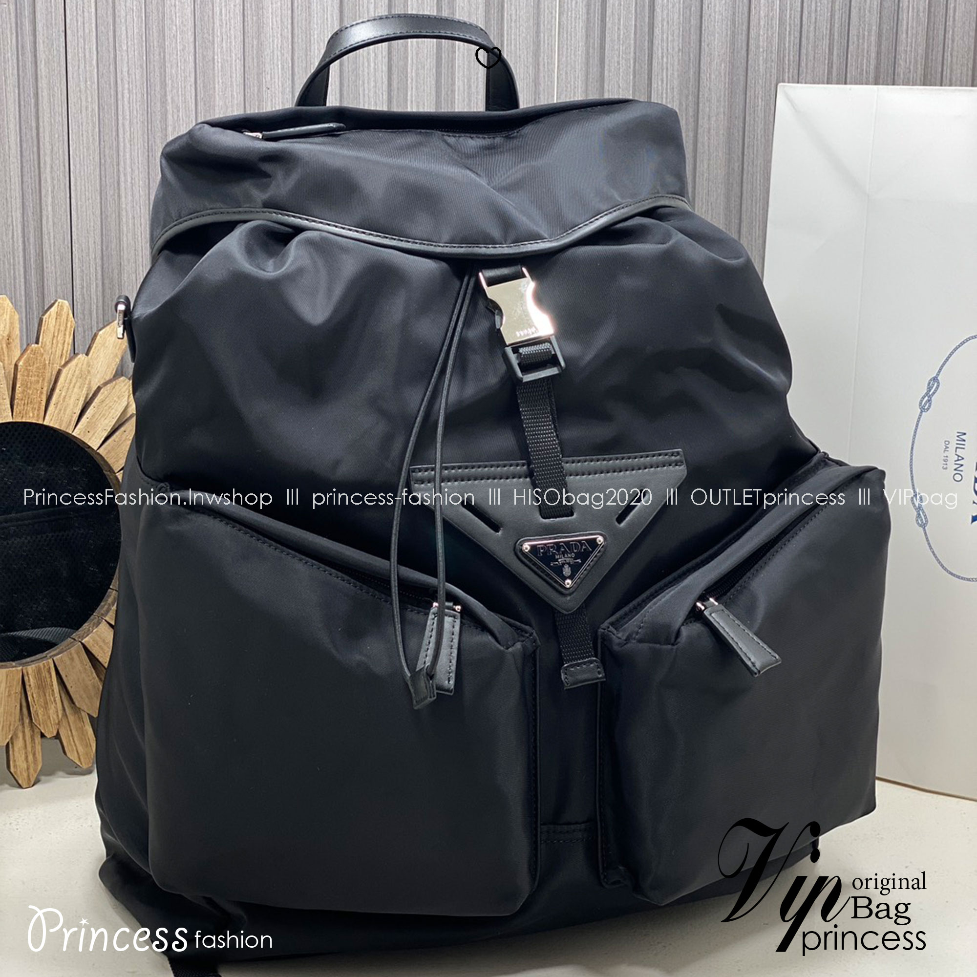 ORI หนังแท้ | Prada Re-Nylon and leather backpack กระเป๋าสะพายหลัง เป้ผ้าไนลอนรูปทรงเรขาคณิตเรียบหรู สถาปัตยกรรมและเส้นสาย ผสมผสานรูปทรงและวัสดุที่ตัดกันอย่างลงตัว