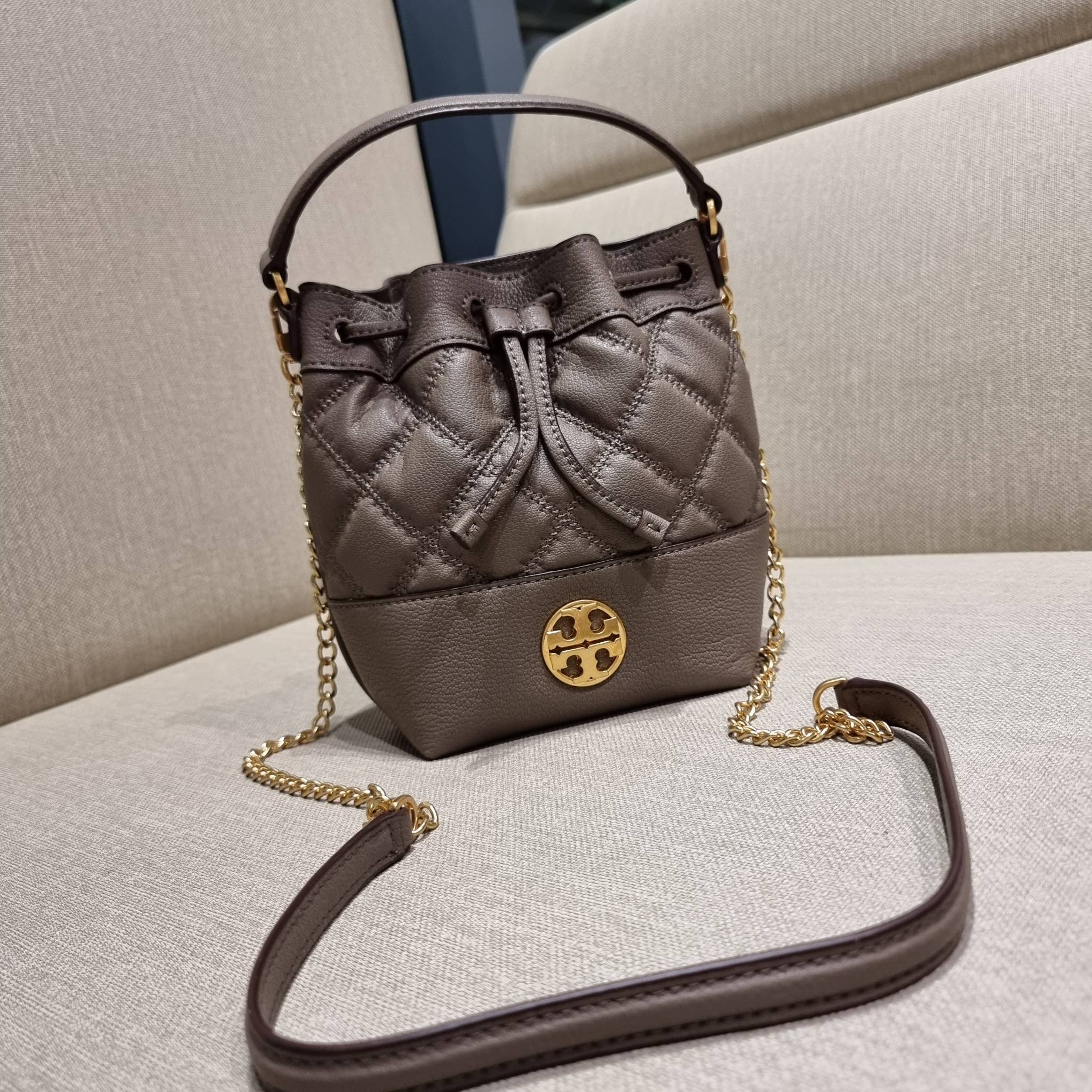 TORY BURCH WILLA MINI BUCKET BAG NEW ARRIVAL สุดปัง กระเป๋าสะพายทรงบัคเก็ต สวยผู้ดี โดดเด่นด้วยโลโก้สีทองดูหรู อัพลุคผู้ดี๊ผู้ดี วัสดุหนังแท้ ดีไซน์บุนวม เส้นคมดีเทลหรู เปิด-ปิดหนังรูดปากกระเป๋า มีหูหิ้วในตัว คล้องแขนเก๋ๆ ภายในเป็นช่องโล่ง มีช่องย่อย ใส่ข