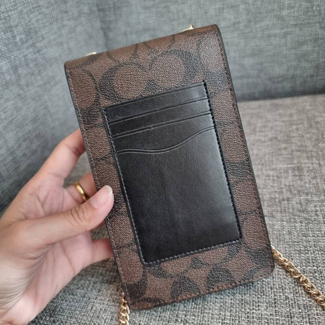 COACH NORTH/SOUTH PHONE CROSSBODY IN SIGNATURE CANVAS F55636 F39955 สุดคลาสสิคกับกระเป๋าสะพายเอนกประสงค์ Case phone ใส่โทรศัพท์มือถือได้ทุกรุ่น ดีไซน์ลายเอกลักษณ์ วัสดุหนังแคนวาสเคลือบลาย ฝาและภายในเป็นหนังสังเคราะห์เรียบ เปิด-ปิดด้วยกระดุม สายสะพายยาวประ