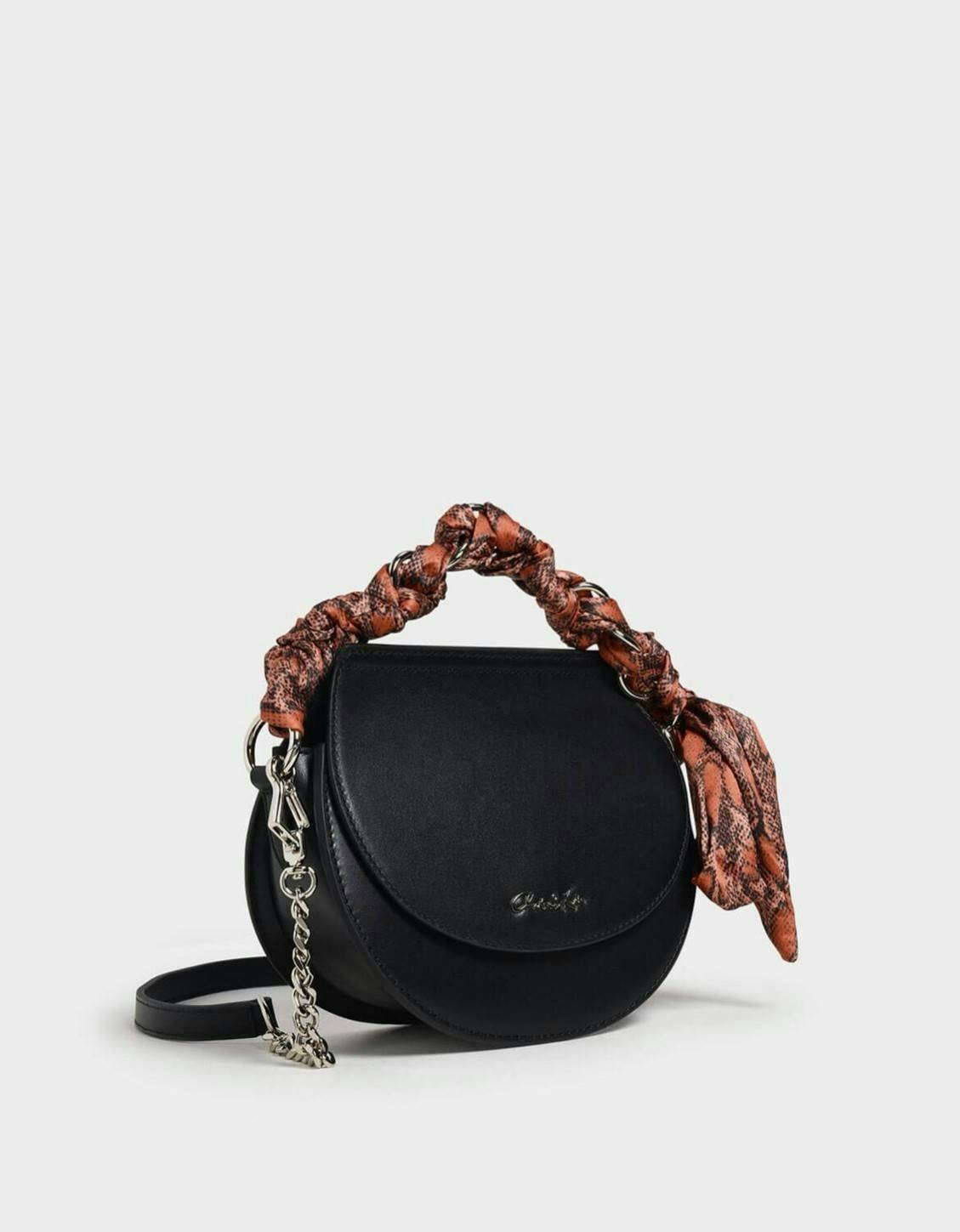 CHARLES & KEITH รุ่น LEATHER SATIN SCARF CROSSBODY BAG SL2-50150828 ราคาปกติช้อป ( ฿3,590.00 ) กระเป๋าถือ และ สะพาย ทรงโค้งมน หนังเรียบ ตั้งอยู่ทรง ด้านหน้าติดโลโก้แบรนด์ อะไหล่เงิน หูจับสายกระเป๋าร้อยเข้ากับห่วงเหล็กกลมๆ ด้วยผ้าลายสวยงามผูกเป็นโบว์เก๋ๆ ถ