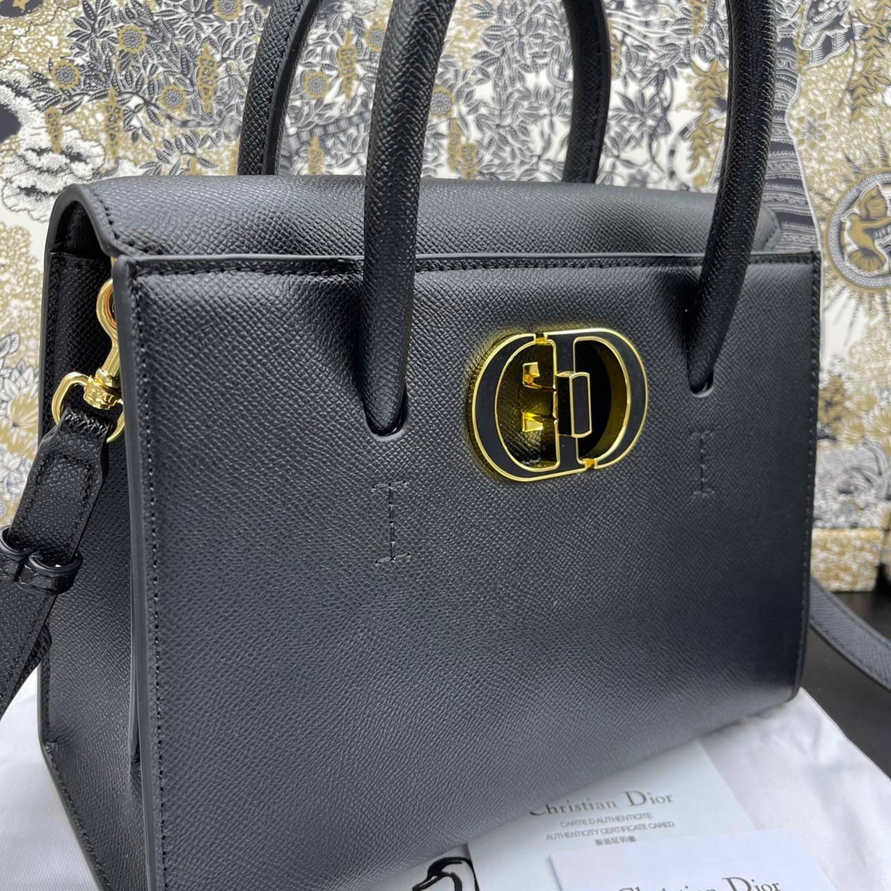 หนังแท้ DIOR Medium ST Honore Tote Collection Fall/Winter 2020-2021 มาในรูปแบบกระเป๋าทรงสี่เหลี่ยมที่ได้มาตรฐาน ทำจากหนังลูกวัว (Calfskin) ลายเกรน ซึ่งสื่อถึงความหรูหราได้อย่างลงตัว ตัวด้ามจับ มีการเย็บเข้าด้านในของกระเป๋าเพื่อเพิ่มความแข็งแรงทนทาน ด้านหน