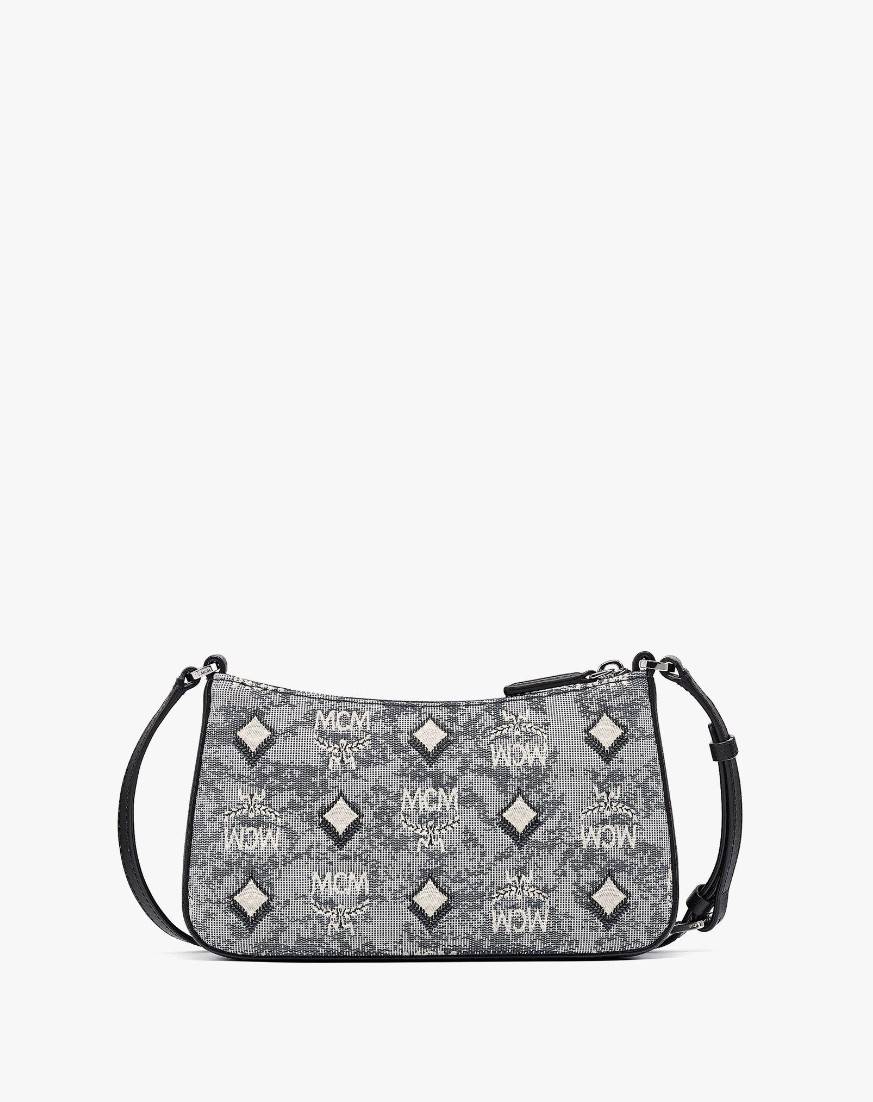 M.C.M MINI SHOULDER BAG IN VINTAGE JACQUARD MONOGRAM คอลเลคชั่นใหม่ล่าสุด โดดเด่นด้วยลายโมโนแกรม ถักทอบนผ้า woven jacquard กระเป๋าสะพายทรงพอชที่ไม่ธรรมดา มาพร้อมสายสะพายในตัว สามารถปรับใช้ได้ 2 แบบ สายยาวสะพายข้าง หรือจะนำสายเส้นกลางออกและปรับใช้สะพายไหล่