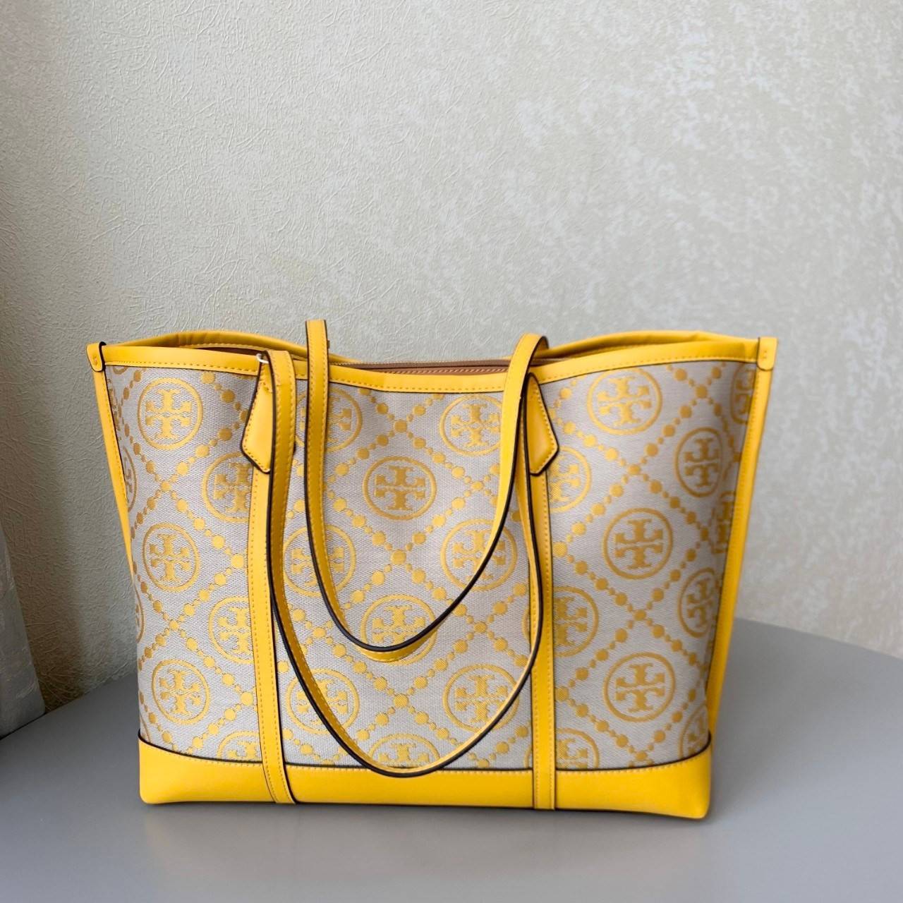 ของแท้ 💯% TORY BURCH PERRY T MONOGRAM TRIPLE-COMPARTMENT TOTE กระเป๋าสะพายทรง SHOPPING BAG ผ้าแคสวาสมปักลายสัญลักษณ์แบรนด์ สวยหรูอยู่ทรง ด้านหน้าปักโลฟดก้ลงบนหนังแท้ ภายในมีข่องใหญ่3ช่อง เป็นช่องซิปและช่องข้างขนาบ2ช่อง กว้างและจุของได้เยอะมาก