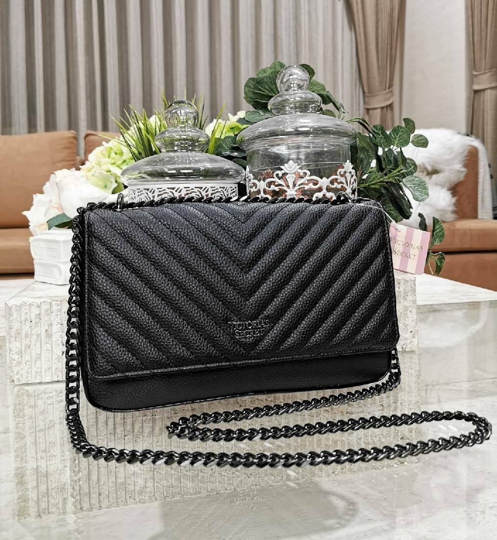 VICTORIA'S SECRET Quilted Chain Crossbody Sling Bag กระเป๋าสะพายรุ่นใหม่ล่าสุดจาก Victoria's Secret วัสดุหนังแกะสังเคราะห์ชึ้นลายริ้วหนังสวยอยู่ทรงไม่ย้วยดีไซน์สุดหรูคุณหนูไฮโซ เปิดปิดด้วยฝาปิดกระดุมแม่เหล็ก ภายในมีโลโก้และช่องใส่ของ ใส่กระเป๋าส