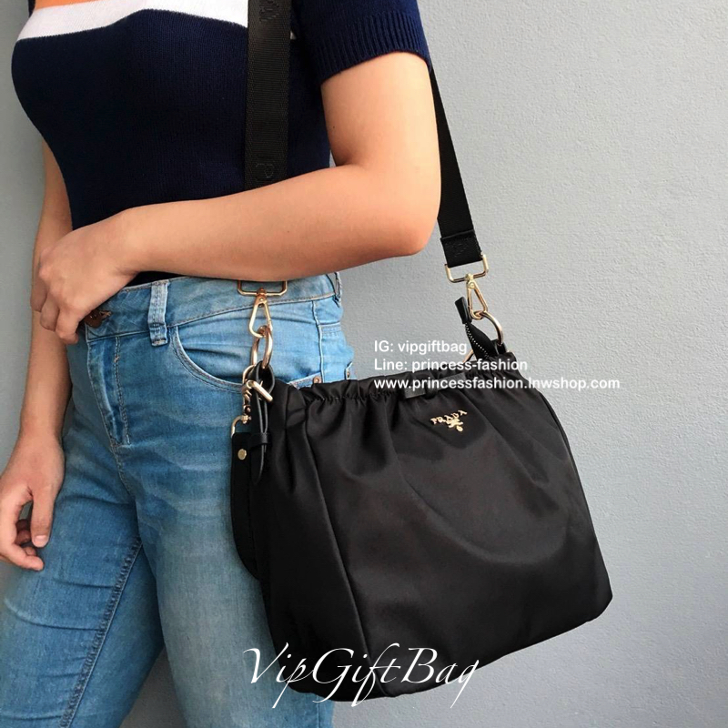 Prada nylon รุ่น Limited edition **กระเป๋าทรงน่ารัก จับจีบปากกระเป๋า ดีมาก วัสดุผ้าNyonกันน้ำ ตามแบบฉบับแบรนด์ เปิด/ปิดด้วยซิป ภายในเย็บติดป้ายหนังแบรนด์ มีช่องซิปเล็ก1 สามารถใส่ของจุกกจิกได้ สามารถใส่IPad mimiได้ มีช่องซิปเล็ก1ช่อง มาพร้อมสายหนังสั้นคล้อ