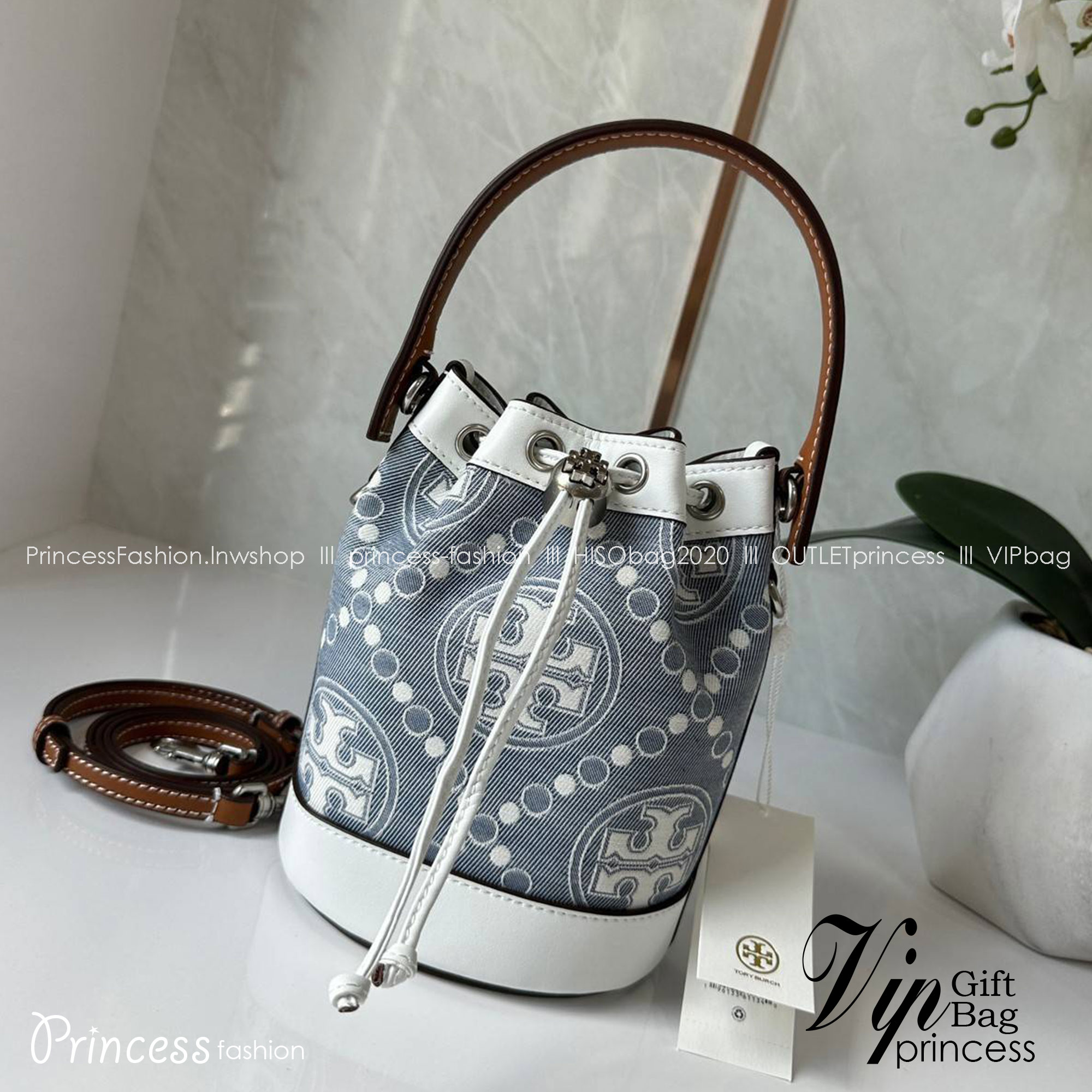 TORY BURCH Mini T Monogram Denim Bucket Bag คอลเลคชั่นใหม่ รูปแบบคลาสสิค พกพาความหรูหราไปได้ทุกที่ด้วยกระเป๋าทรง Bucket ขนาดกลางและปิดด้วยเชือกรูดพร้อมโลโก้แวววาว วัสดุผ้าเดนิมแจ็คการ์ด ตัดขอบหนังแท้ สวยหรู ทันสมัยสุดๆคะ