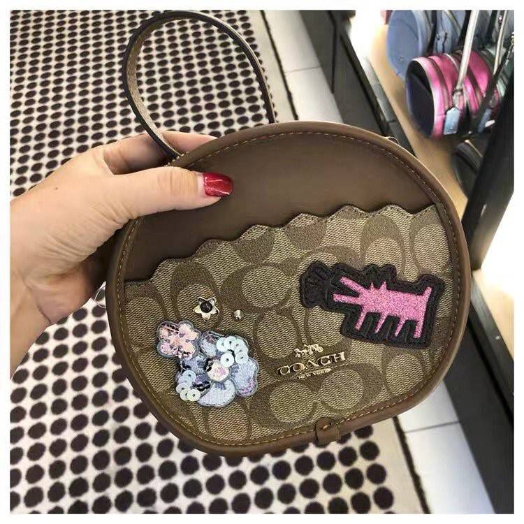 COACH KEITH HARING CANTEEN CROSSBODY IN SIGNATURE CANVAS WITH PATCHES F48730 กระเป๋าทรงกลมสุดเก๋ ไม่เหมือนใคร ตกแต่งลายให้มรความน่ารัก โดดเด่นขึ้นมา สะพายไปไหนก็สวยไม่เหมือนใคร ภายในกว้าง ใส่ของได้เยอะ กระเป๋าเปิดปิดด้วยซิป ใครย้งไม่มี รีบจับ รีบจองกันเลย