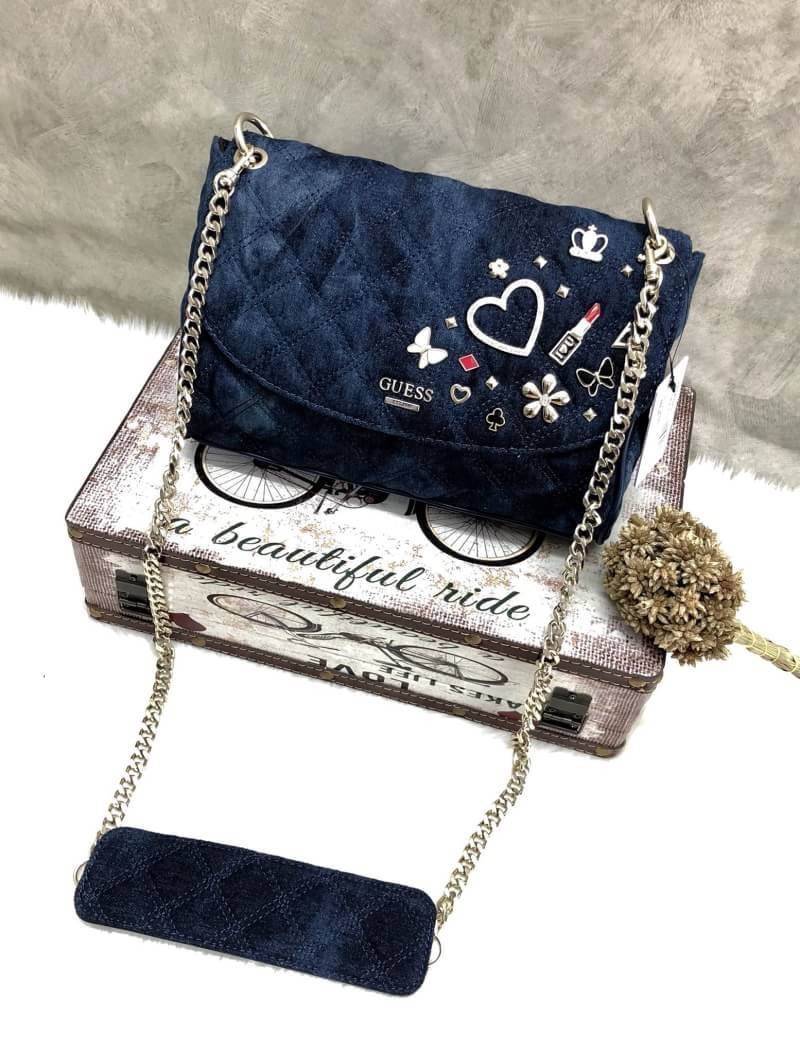 GUESS WOMEN BAG JEAN กระเป๋าสะพายไหล่หรือ crossbody สุดชิค วัสดุผ้ายีนส์ ด้านหน้าติด logo brand เพิ่มดีเทลดีไซน์ตกแต่งที่ด้านหน้ากระเป๋า เปิดปิดกระเป๋าแบบแม่เหล็ก ใช้งานง่าย ภายในมี 2 ช่อง แต่ละช่องกว้างใส่ของได้จุ และยังมีช่องซิปเล็กใส่ของจุกจิกได้อีกค่ะ
