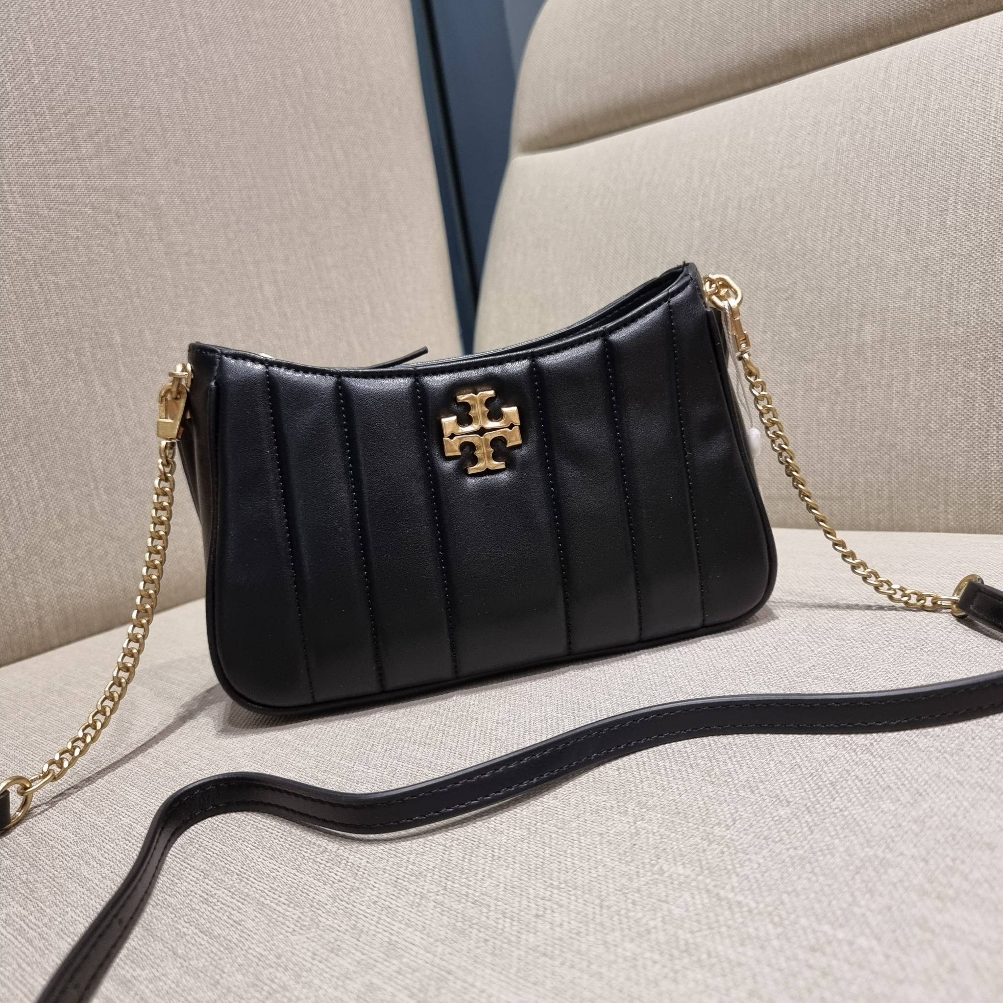 TORY BURCH KIRA MINI BAG กระเป๋าสะพายทรงพอช ง่ายต่อชีวิต!! ดีไซน์บุนวม เส้นคมสวยหรู วัสดุหนังแกะ สัมผัสดีงาม นิ่มมือ เปิด-ปิดด้วยซิป ภายในเป็นช่องโล่ง มีช่องใส่บัตร ใส่ของสำคัญได้ครบถ้วน มาพร้อมสายคล้องไหล่ในตัว และสายสะพายครอส ปรับได้ตามสะดวก ใบจริงสวยคม