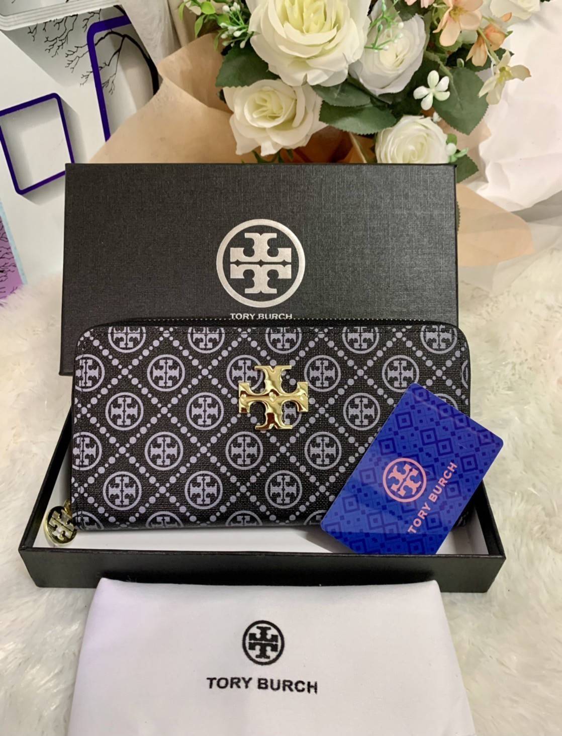 กระเป๋าสตางค์ใบยาว TORY BURCH : Monogram Pattern วัสดุหนังแกะสังเคราะห์ลงเคลือบเพิ่มความเงาอีกชั้น อะไหล่สีทอง **แบบซิปรอบ เปิด - ปิด กระเป๋าด้วยซิปรอบ ด้านในแบ่งออกเป็น 3 Patation ตรงกลางเป็นซิปยาว มีช่องใส่บัตรได้ 8 ใบ หนังเงาสวย จับถนัดมือ พร้อมส่งให้ส
