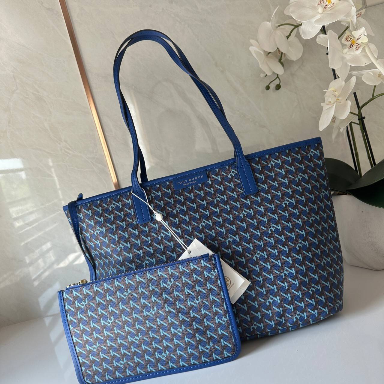 Tory Burch Ever Ready Zip Tote Small Coated Canvas / Tory Burch Geo Logo Tote กระเป๋าโท้ท พิมพ์ลายด้วยลวดลายสานตะกร้าอันเป็นเอกลักษณ์ของแบรนด์ ซึ่งได้แรงบันดาลใจจากความหลงใหลในงานจักสานของผู้ก่อตั้ง
