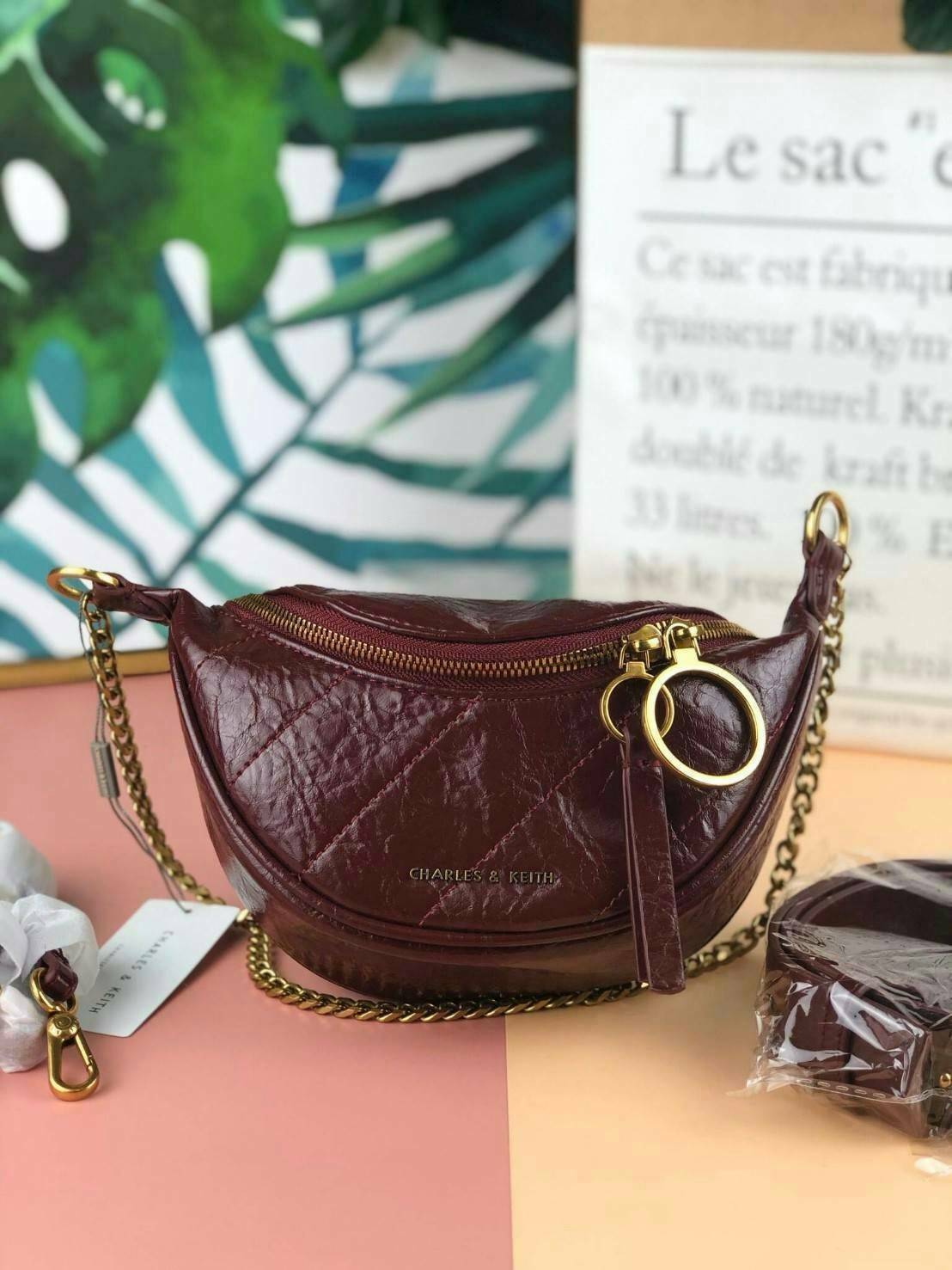 CHARLES & KEITH WRINKLED EFFECT RING ZIP TASSEL CROSSBODY BAG กระเป๋าสาระพัดประโยชน์ ใช้คาเอว คาดอก หรือจะสะพายแบบครอสบอดี้ได้ค่า 💥💥 มีโลโก้แบรนด์ที่ด้านหน้า เปิดปิดแบบซิปคู่เก๋ๆ ด้านในมีช่องใส่บัตรได้ 3 ช่อง รุ่นนี้ใส่ iPhone plus ได้พอดี