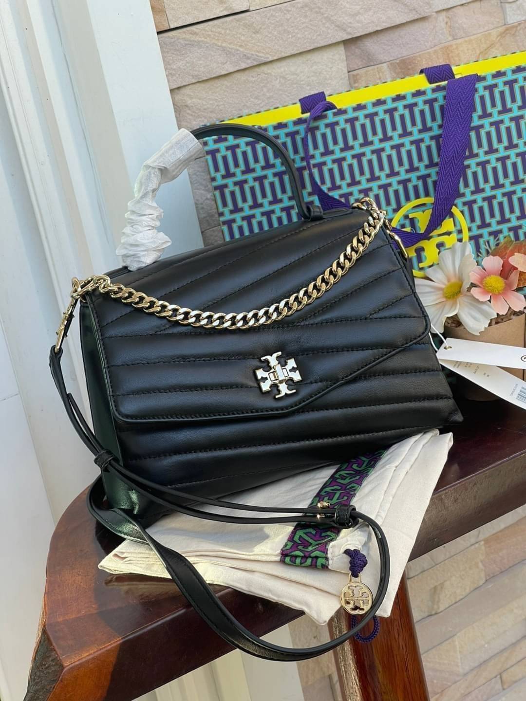 TORY BURCH Kira Chevron Top-handle Satchel กระเป๋าหนังแกะ สัมผัสนุ่มควบคู่กับดีไซน์อันเป็นเอกลักษณ์ กระเป๋าถือทรงสวยที่มีดีไซน์อันเป็นเอกลักษณ์ไม่เหมือนกับที่ไหน ด้วยการตัดเย็บหนังแกะแสนนุ่มแบบลายบุสองชั้น เพิ่มมูลค่าด้วยสายสะพายที่ทำจากโลหะสีทอง อีกทั้งย