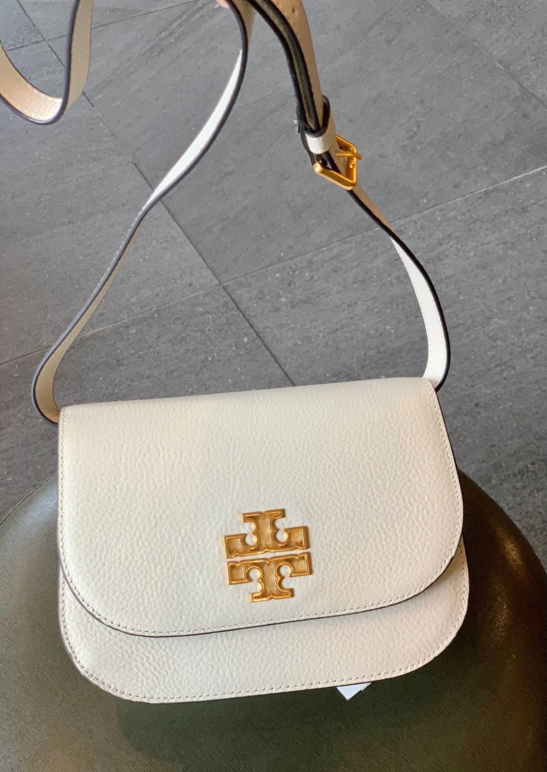 TORY BURCH BRLTTEN SMALL SADDLE BAG / Tory Burch Britten Flap Shoulder Bag กระเป๋าสะพายข้าง วัสดุหนังแกะแท้ ด้านหน้าประดับโลโก้แบรนด์ เปิด-ปิดกระเป๋าแบบกระดุมแป็กแม่เหล็กแน่นหนา ภายในมีช่องหลัก ใส่กระเป๋าเงินใบกลาง มือถือได้ทุกรุ่น มีช่องแยกใส่ของจุกจิกอี